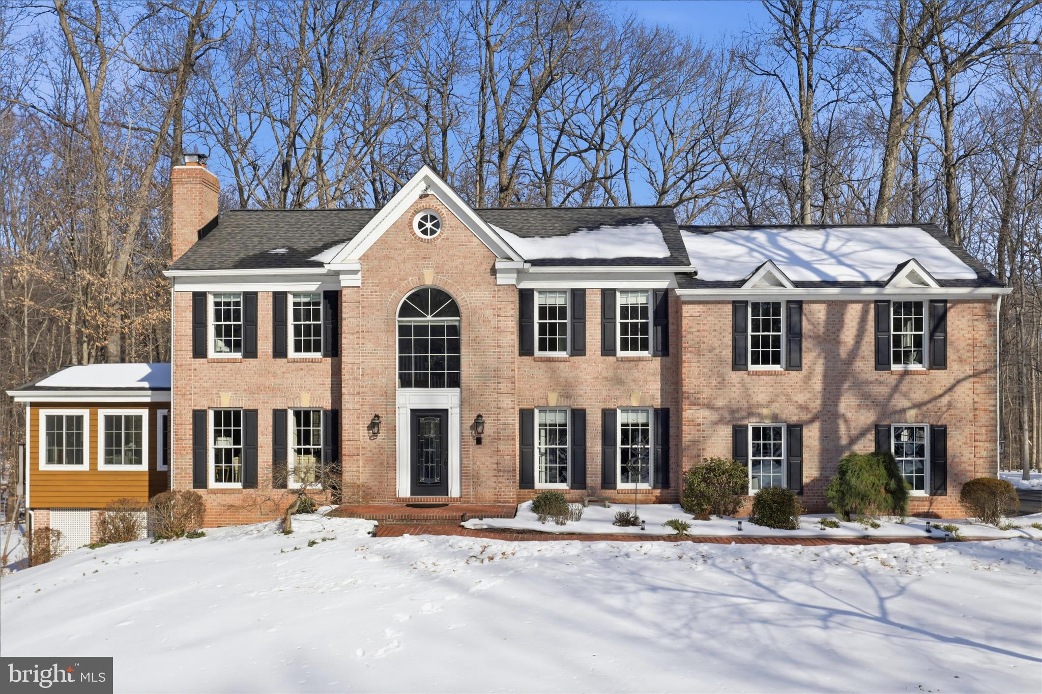 Welcome to this beautifully maintained, custom-built estate offering just over 5,000 square feet of refined living space on 5 beautiful acres in the highly sought-after Patterns neighborhood of Fairfax Station. With direct access to scenic horse trails and a private, gated entrance, this remarkable property delivers the perfect balance of luxury, privacy, and everyday comfort. It's just a short distance to the charming town of Clifton. 
Designed for both gracious living and effortless entertaining, this home welcomes you with a dramatic two-story foyer, curved staircase, and elegant architectural details throughout. The main level features formal living and dining rooms, each with wood-burning fireplaces, hardwood flooring, and abundant natural light. A private study with French doors and crown molding provides an ideal work-from-home retreat.
The gourmet kitchen is thoughtfully designed with granite countertops, heated tile floors, a center island with cooktop, Jenn-Air appliances, farmhouse sink, multiple pantries, and a butler’s pantry. A sunny breakfast area and walk-out access to the deck create a seamless flow for indoor-outdoor living. Just off the kitchen, the family room showcases vaulted ceilings, atrium windows, hardwood flooring, and a cozy wood-burning fireplace.
The inviting sunroom features cedar framing, exposed beams, tile flooring, and access to the slate patio—perfect for relaxing year-round while enjoying peaceful woodland views.
Upstairs, the luxurious primary suite offers vaulted ceilings, hardwood floors, dual walk-in closets, and a spa-inspired bath with soaking tub, walk-in shower, granite double vanity, and custom cabinetry. Three additional bedrooms provide ample space, including one with a built-in granite desk and another with crown molding and attic access. A well-appointed hall bath completes the upper level.
The fully finished lower level expands your living space with a large recreation room, wood stove, built-in bookcases, walk-out access, and a full bath. A second kitchen with granite countertops and double ovens makes this level ideal for guests, extended family, or entertaining. Additional spaces include a bonus room that could be used as a 5th bedroom, workshop, utility room, and abundant storage.
Practical features include a mudroom with laundry chute, sink, cabinetry, and exterior access, as well as an oversized two-car garage with epoxy flooring, built-in storage, and keypad entry.
Outdoor living is equally impressive. Enjoy the TimberTech deck with built-in lighting, which leads to a slate patio with firepit and gazebo. The professionally landscaped grounds feature mature Japanese maples and dogwoods, offering year-round beauty and privacy. A storage area beneath the sunroom provides convenient access to mechanical systems and additional space.
Close to all the major commuter routes, shopping and so much more.  Get ready to fall in love!!