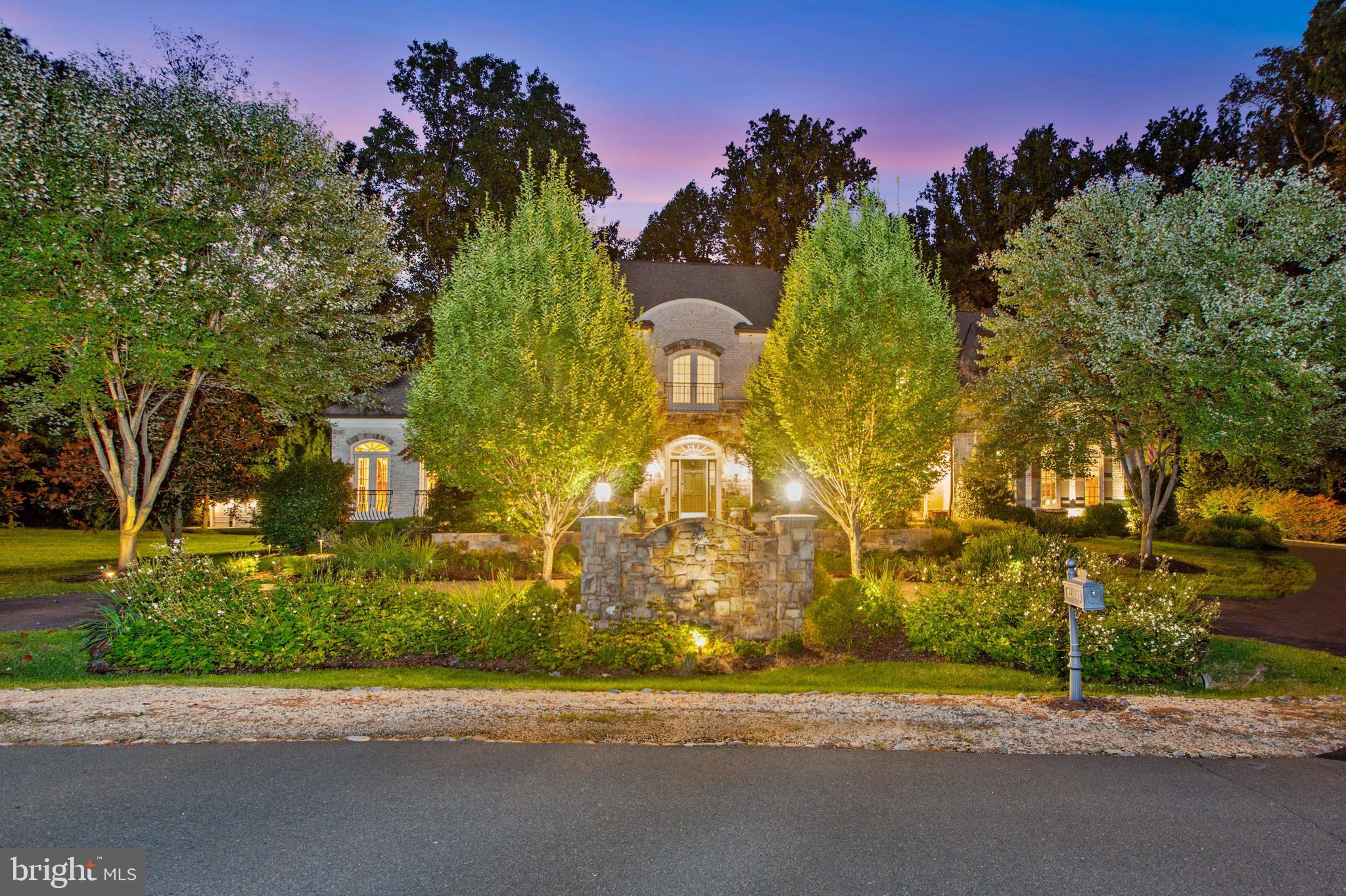 This elegant stone and brick manor home is a jewel nestled in a charming cul-de-sac with serene landscaped grounds and a rockstar backyard!  Rediscover elegance when you enter the gracious 2-story Foyer with a floor-to-ceiling window on the rear wall that showcases the graceful curved staircase that takes you to the Upper & Lower Levels. The Main Level includes a formal Living Room with beautiful mouldings, Dining Room with custom built-ins for china and linens, Music Room/Conservatory, Office with built-in cabinetry, warm, inviting Family Room retreat with stone fireplace beamed ceiling and wall-of-windows, the renovated Kitchen that has custom cabinets with glass doors, top-of-the-line appliances, large center Island, marble countertops and walk-in Pantry, Breakfast Area with windows and access to the outdoor living space, Desk Area with built-ins and cabinetry, Butler’s Pantry with built-in cabinetry, complete with a wine cooler, Mud Room with cabinets, sink, cubbies and access to the garage and backyard. The Upper Level has an exceptional Owner’s Suite with custom built-ins that includes a fireplace, amazing designer walk-in custom closet, French doors to the balcony overlooking the backyard oasis, Spa Bath with gorgeous shower, double vanities, large tub and 3 additional walk-in closets. There are 3 additional en suite Bedrooms and Loft with built-ins and desk area. The upstairs laundry is convenient to the Owner's Suite with stairs to the Main Level. The Lower Level has a large Recreation Room with fireplace, Bar with full Kitchen, Billiards area, Game Room, Movie Room, Wine Cellar, Gym, Bedroom, Full Bath and additional storage. The truly resort backyard is great for entertaining or just family fun. There is an outdoor built-in Grill area next to the Cabana that has a Kitchen and Bar, Family Room with fireplace and TV, Bath/Changing Room and automatic retractable screens making it perfect for year-round enjoyment. The state-of-the-art saltwater pool built by Town and Country Pools has a pebble tec finish, in-ground caretaker cleaning system, iAqualink app control, 4 deck jets, 2 fountains, gas heater, HVAC heat recovery and water cooling unit so you can have the perfect temperature year-round. Minutes to dining, grocery stores and the finest shopping in the Washington area!