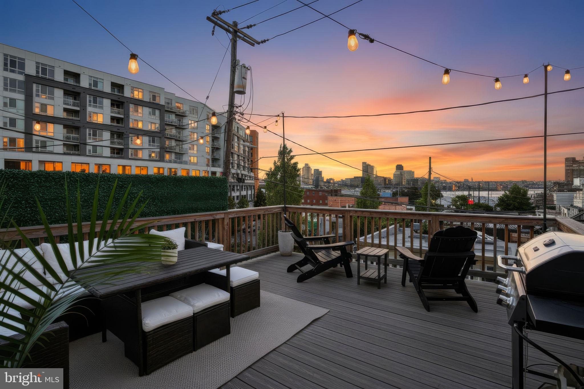 Welcome to 1024 E Fort Avenue — a 14 foot wide, beautifully maintained Baltimore rowhome blending timeless charm with modern comfort, complete with private outdoor spaces, rear parking, and stunning city and water views.

The main level welcomes you into a bright and inviting living room, highlighted by a huge front-facing window that fills the space with natural light. Rich hardwood floors flow throughout the home, leading seamlessly into the dining area and open kitchen. Designed for both everyday living and entertaining, the kitchen features a large center island, built-ins, stainless steel appliances, and abundant cabinet storage. Toward the rear of the home, the bright mud room area continues the airy feel and provides convenient access to the private rear parking pad. A stylish half bath completes the main level.

Upstairs, the upper level serves as a spacious primary suite loft with an open and airy atmosphere. The luxurious full bath is complete with a walk-in shower and modern finishes, while the expansive layout offers plenty of room to relax and unwind. A second upstairs bedroom provides excellent flexibility and could easily function as a home office, lounge, or additional living space. From the primary suite, step out onto your private deck — the perfect outdoor oasis for enjoying the sun and fresh air.  The new composite deck has breathtaking skyline and water views that create an incredible backdrop for entertaining or quiet evenings at home.

The lower level expands the home’s functionality with additional storage space, easy access to utilities, and a dedicated laundry area. While currently unfinished, the basement offers tremendous potential for future customization to suit your needs.

Located in the heart of Locust Point, this home places you just moments from some of Baltimore’s best amenities and attractions. Enjoy easy access to the waterfront, Latrobe Park, and Fort McHenry, along with a variety of popular restaurants, breweries, coffee shops, and local boutiques nearby. The neighborhood also offers quick commuter access to downtown Baltimore, I-95, and the Inner Harbor, making this location as convenient as it is vibrant.

With spacious interiors, multiple outdoor living spaces, private off-street parking, and an unbeatable city location, 1024 E Fort Avenue offers the perfect balance of charm, comfort, and lifestyle.