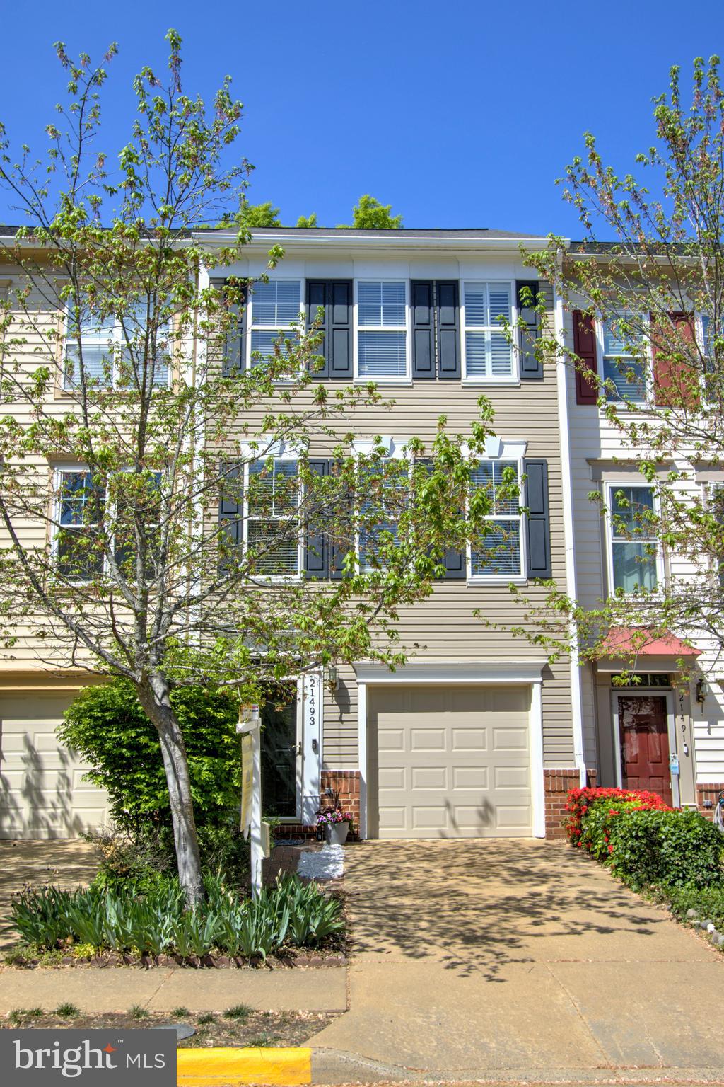 Absolutely charming  3-bedroom garage townhome in Broadlands! This home offers three finished levels, featuring a cozy gas fireplace and hardwood floors throughout the main level. Numerous upgrades enhance its charm. The kitchen features gas cooking, white cabinets, and sleek black stainless appliances, opening to a spacious Trex deck that overlooks the fenced backyard. The renovated primary bathroom features beautiful white cabinetry, dual sinks, quartz countertops, and chic shiplap walls, adding a modern flair.  Walk through this home right now by clicking on the "Tours" button to access the 3D Matterport tour. 
 Recent updates include a new deck (2024), furnace and A/C (2017), and water heater (2010). With its inviting features and thoughtful improvements, this home is ready for you to move in!  Come see!