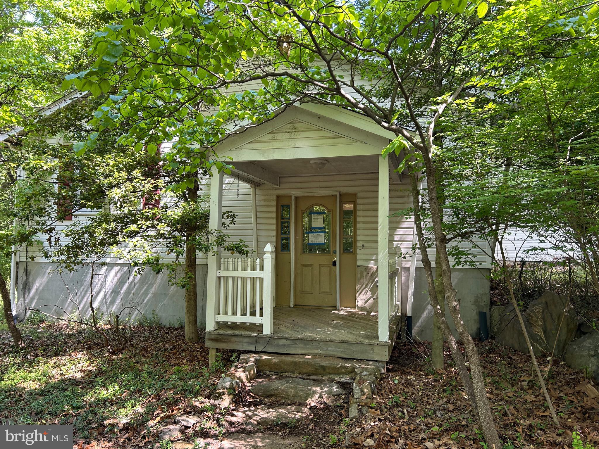 Excellent rehab opportunity in a great location near the Mountain Lake Club in Shannondale. Three large bedrooms and two baths, along with a very large living room, formal dining room, breakfast room and kitchen are all available on the main floor, with a lower level family room, laundry and craft room. Home is in need of complete rehab, with yard and landscaping cleanup. It is still winterized, and is sold strictly "AS-IS".