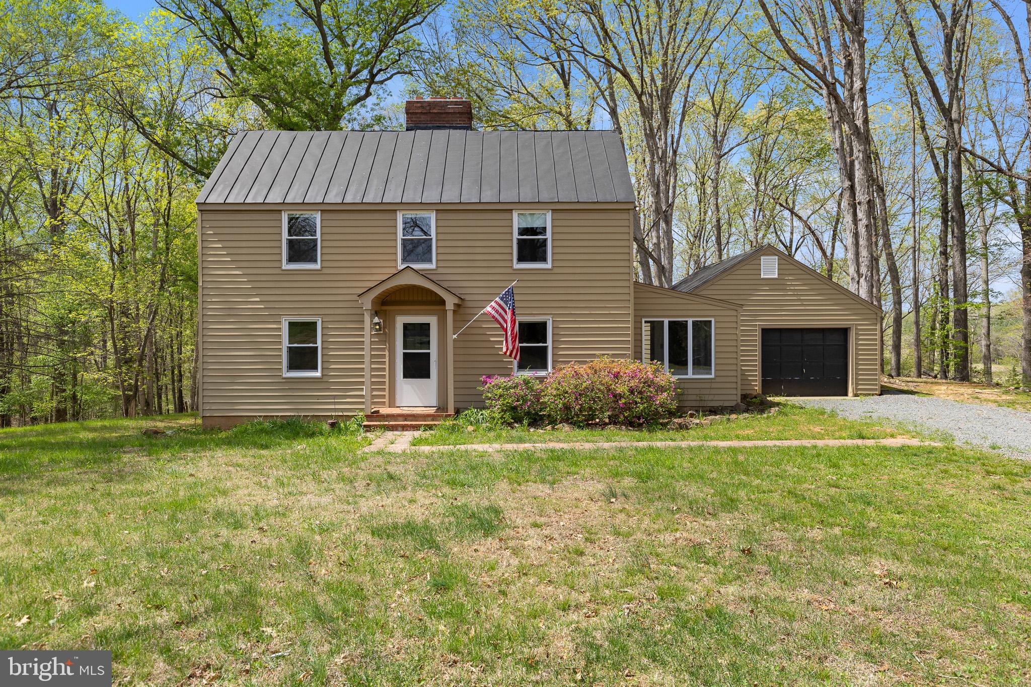 8358 Botha Rd, Warrenton, VA 20186 offers a farmhouse-style home on more than 6 private acres with elevated views of surrounding pastures and woodlands. The home includes 3 bedrooms, 1.5 baths, a sunroom, an oversized detached-style garage connected by an enclosed breezeway, and a full unfinished basement providing additional storage and utility space. Interior details include hardwood floors, exposed wood-beam ceilings, wood trim and paneling, a brick fireplace, and abundant natural light throughout. The kitchen features wood cabinetry, solid-surface counters, and updated flooring. One bedroom includes direct access to a private half bath, and the additional full bath includes a tub/shower combination. Outside, the property offers open lawn areas, mature trees, a long gravel driveway, and a private setting with usable acreage. Set in a scenic Warrenton location, this property combines functional living space, character-filled interior details, and a quiet rural setting.