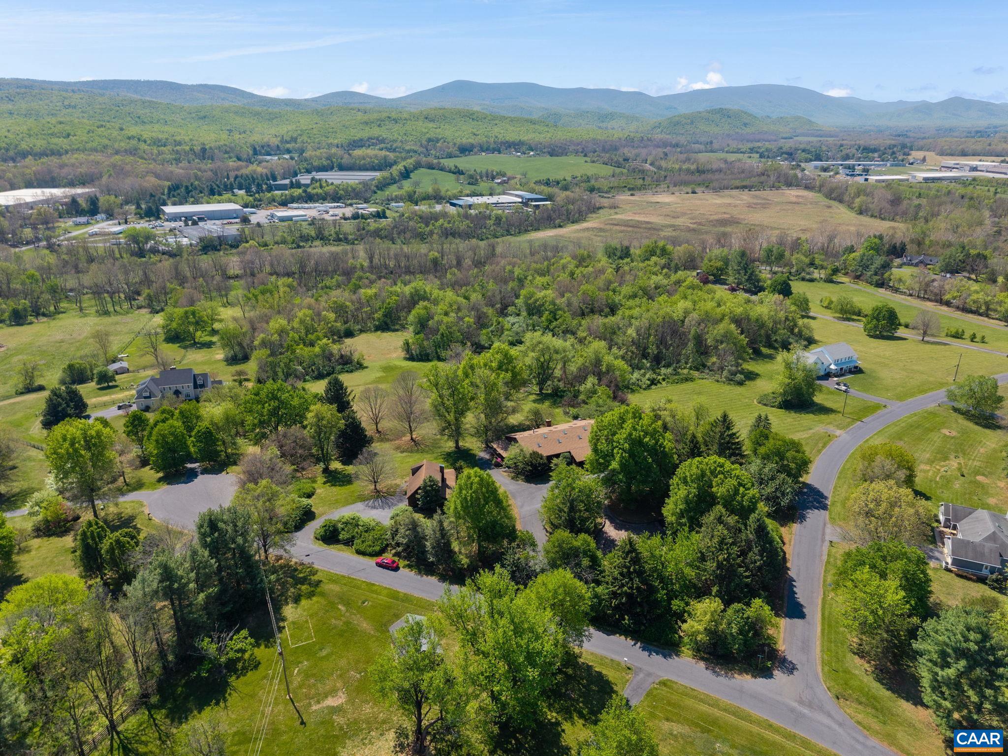 NEW PRICE:  Rare Shenandoah Valley creative compound with two residences, 13.81 acres, river frontage, and the former home/studio of renowned artist P. Buckley.   Zoned Residential. Distinctive opportunity to reimagine a truly one-of-a-kind creative space. Situated on 13.81 scenic acres with South River frontage and a separate buildable parcel, the property includes two residences and exceptional flexible space ideal for artists, entrepreneurs, multi-generational living, retreat use, or a private estate setting. The centerpiece is a dramatic 5,000+ sq ft former apple barn transformed into an expansive live/work environment featuring soaring ceilings, open studio space, lofts, oversized gathering areas, kitchen, dining space, multiple baths, and an unfinished walk-out basement ready for customization. A separate guest residence provides additional living flexibility for extended family, caretakers, guests, or rental potential. Mature trees, mountain surroundings, and open land create a peaceful setting with endless vision potential. Rich in history, character, and scale, this property offers the rare chance to own an inspiring legacy estate in the heart of the Shenandoah Valley.,Fireplace in Living Room
