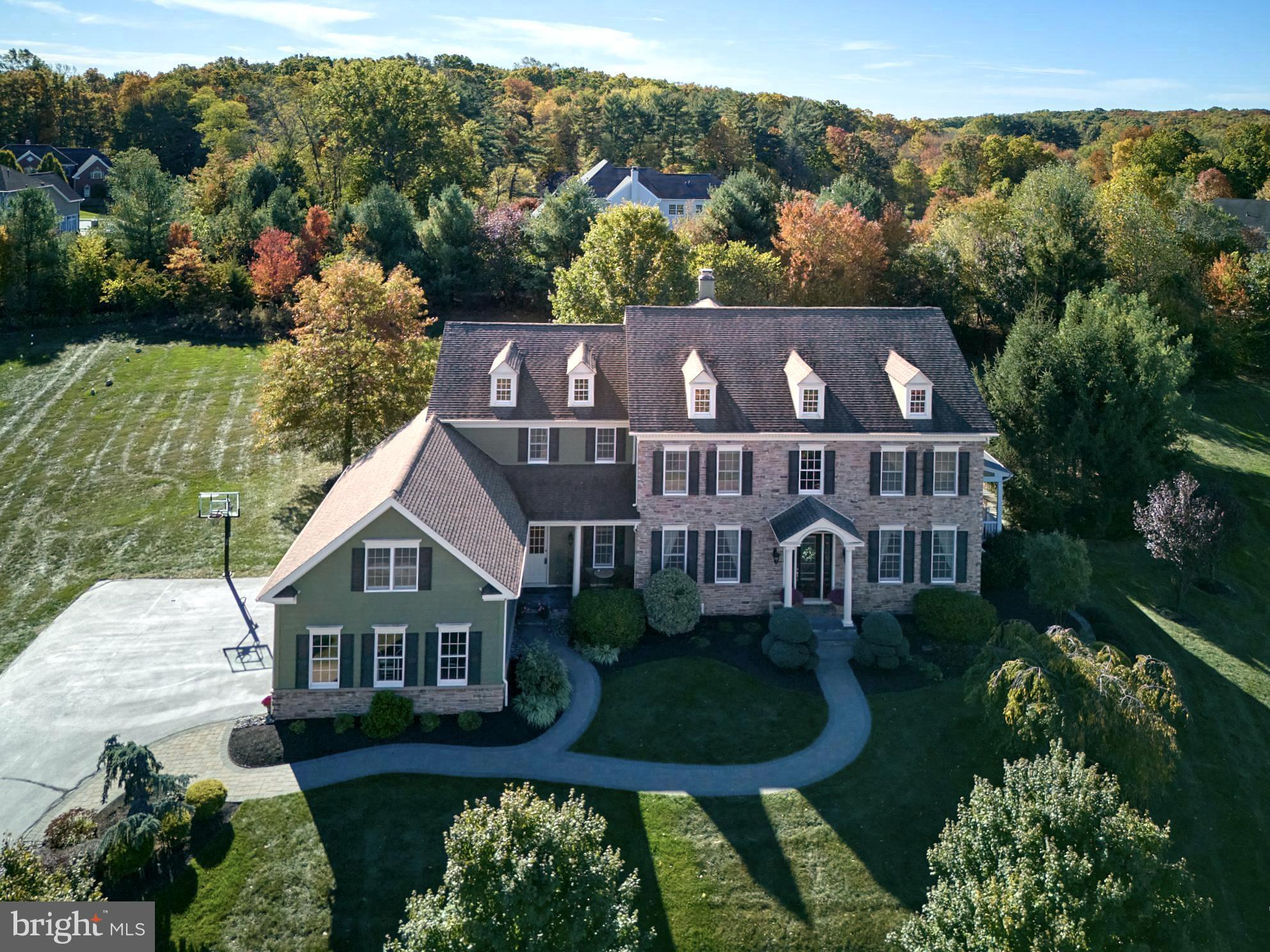 Welcome to Spring Valley Estates, a coveted and secluded enclave, located in Buckingham Township and award winning Central Bucks School District, minutes from the historic river towns of Doylestown  and New Hope, as well as shops, galleries, theatre, museums, restaurants, farmers markets, vibrant arts, culture and so much more. Exuding curb appeal and warmth, the keynotes of this residence are comfort, luxury and tradition.  The significant stone front is the perfect anchor to its gracious, verdant setting.  The entry foyer is flanked by formal living and dining rooms and offers a sweeping view through the distant family room windows.  Wood flooring throughout gleams and unifies the main level.  The oversized family room is centered on a stone fireplace, referencing back to the front exterior.  The vast kitchen area features a long center island, granite counters, abundant cabinet space, walk in pantry, back stairs to the second floor, a sunny breakfast room and glorious banks of windows providing pristine views.  A study, laundry room and half bath complete the main level.  Upstairs, the serene main bedroom suite is bathed in soft, diffused light, contains 2 custom walk in closets and spacious bath.  Bedrooms 2 and 3 both contain walk in closets and en suite bathrooms.  Bedroom 4 has access to a hall bath.  A tremendous bonus room could serve many uses.  The finished lower level affords space for casual entertainment as well as storage and contains a full bath.   Additional comforts include a 17,000kw  hardwired generator,  wrap around porch. salt water pool, spa and hardscape patio.  Lush tree lined open space and walking paths are mere steps from the front door.  Truly a very special property, it beckons Home Sweet Home.   A 1 year home warranty is included for the buyer.