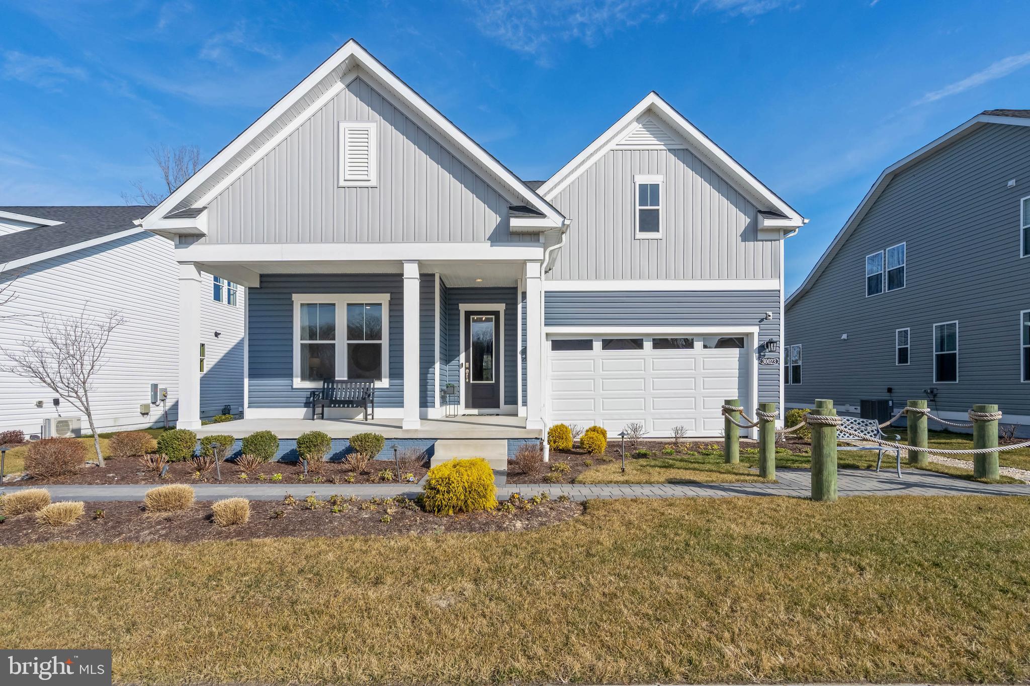 This exceptional home, currently serving as the DRB model, offers a rare opportunity to own a never-lived-in, professionally designed coastal ranch that will be fully converted by the end of April. Showcasing the highly sought-after Latitude floor plan, this home is thoughtfully decorated with custom paint & moldings as well as upscale window treatments throughout. The inviting layout features two guest bedrooms and a guest bath at the front of the home, while the private primary suite is tucked away in the rear corner, creating ideal separation for owners and guests. A stunning vaulted ceiling elevates the great room, kitchen, and dining areas, giving the home an open, airy, and grand feel, while the two-sided gas fireplace adds a touch of luxury and can be enjoyed from both the great room and the screened porch.

At the heart of the home is a true gourmet kitchen, equipped with a stainless steel applianced including anatural gas cooktop, double wall ovens, a French door refrigerator, dishwasher, and microwave, and even a washer and dryer. Step through the dining room sliding glass doors to the screened porch, which is perfect for outdoor relaxation and entertaining, and continue outside to the paver patio, an ideal space for grilling or gathering around a firepit. The homesite offers peaceful pond views with a wooded backdrop, adding to the home’s serene coastal feel. This move-in-ready, never-occupied home could be yours just in time to enjoy the upcoming summer season in coastal Delaware. The primary suite features a double vanity, a large walk-in closet, and a spacious walk-in shower with a tiled seat.

Chase Oaks also boasts truly unmatched resort-style amenities, highlighted by a spacious clubhouse with a large gathering area, a built-in bar with wall-mounted television, a fully equipped workout room, pickleball courts, and an incredible pool complete with cabanas and a community firepit—perfect for socializing, relaxing, and enjoying the best of Lewes living.