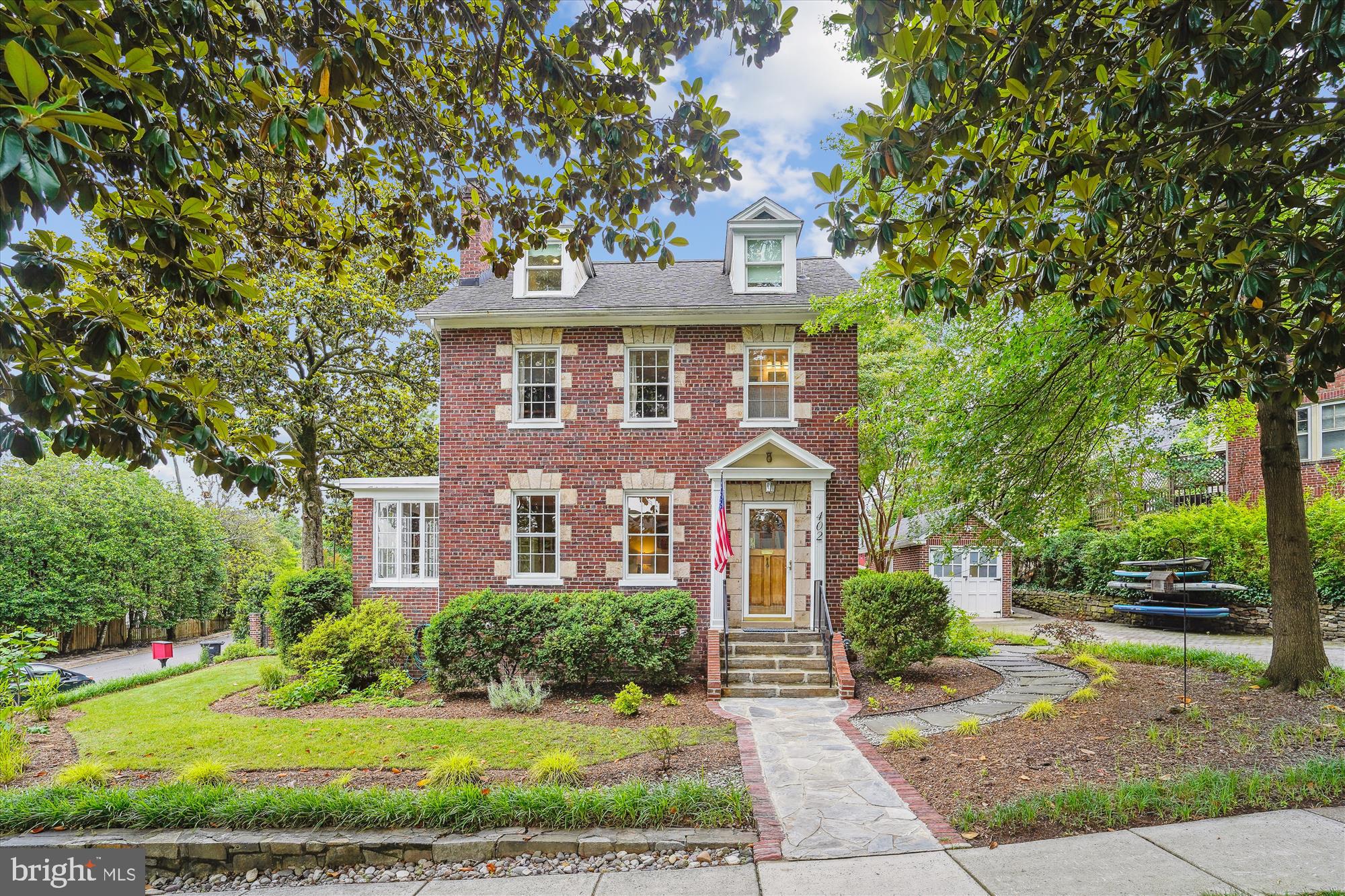 Welcome to this updated, quintessential Rosemont Colonial nestled in one of Alexandria’s most distinguished neighborhoods. Don't miss the video link included within the listing! This timeless 1925 brick home features four upper level bedrooms, three full bathrooms and a main level powder room, and combines classic architecture with contemporary luxury. Step inside to find gleaming hardwood floors, rich crown molding, and an abundance of natural light. A chef’s dream awaits you in the completely reimagined gourmet kitchen. Renovated in 2024, it boasts gorgeous soapstone countertops, a Sub-Zero refrigerator, a Wolf six-burner range, a Fisher and Paykel two drawer dishwasher and custom white shaker cabinetry with soft-close drawers. An expansive peninsula provides ample storage, comfortably seats three and seamlessly joins the kitchen and family room gathering spaces for an open and inviting vibe. The traditional dining room is centered around a gas fireplace with a custom mantel and flows into a bright sunroom on the east side of the home, creating a cozy yet refined space for quietly relaxing or enjoying music and conversation. Also on this level you'll find a conveniently located, stylishly designed powder room. Up one flight you'll find three generously-sized bedrooms and a gorgeous full bathroom featuring exquisite  marble tile, a pedestal sink, a glass framed tub/shower and luxurious radiant floors. The uppermost level is the primary suite: your personal sanctuary, enhanced by a brand-new, spa-inspired en-suite bathroom featuring heated marble floors, a custom double vanity, an oversized walk-in shower with frameless glass enclosure and dual controls, and a water closet that's home to a Toto Aquia IV toilet with bidet. This  bedroom features custom built-ins, loads of windows and ample space for a king-sized bed. A walk-in closet completes this dreamy retreat. The finished lower level offers a versatile bonus room, a full bathroom, two laundry areas and a kitchenette—ideal for a guest suite, home office or fitness room. Here you'll also find generous storage and a side exterior access door, offering many possibilities for utilization of space. Step outside onto your private, landscaped patio and yard, perfect for summer barbecues or morning coffee under the mature trees. A charming stone path leads to a coveted detached garage that's perfect for all of your gear and hobbies, and a long driveway provides plentiful off-street parking. Also noteworthy is that this home's mechanical systems have been updated or added within the last year: a Navien tankless hot water heater with triple filtration system, new heating and cooling systems throughout, an updated electrical panel, and a SpringWell full home water purification system, will enable you to cast your cares aside and enjoy "only the fun stuff" the area has to offer! Whether loading up your bikes or boards, browsing the local shops for home decor or hitting the nearby farmers markets, you're in close proximity to all the fun and every convenience. Within sight of the George Washington Masonic National Memorial, a few minutes' stroll to the King Street and Braddock Metros, Old Town and Del Ray, and featuring easy access to I-395, Reagan National Airport and The Pentagon, don’t miss this rare opportunity to own a stunning, move-in ready home in one of Alexandria’s most desirable neighborhoods.