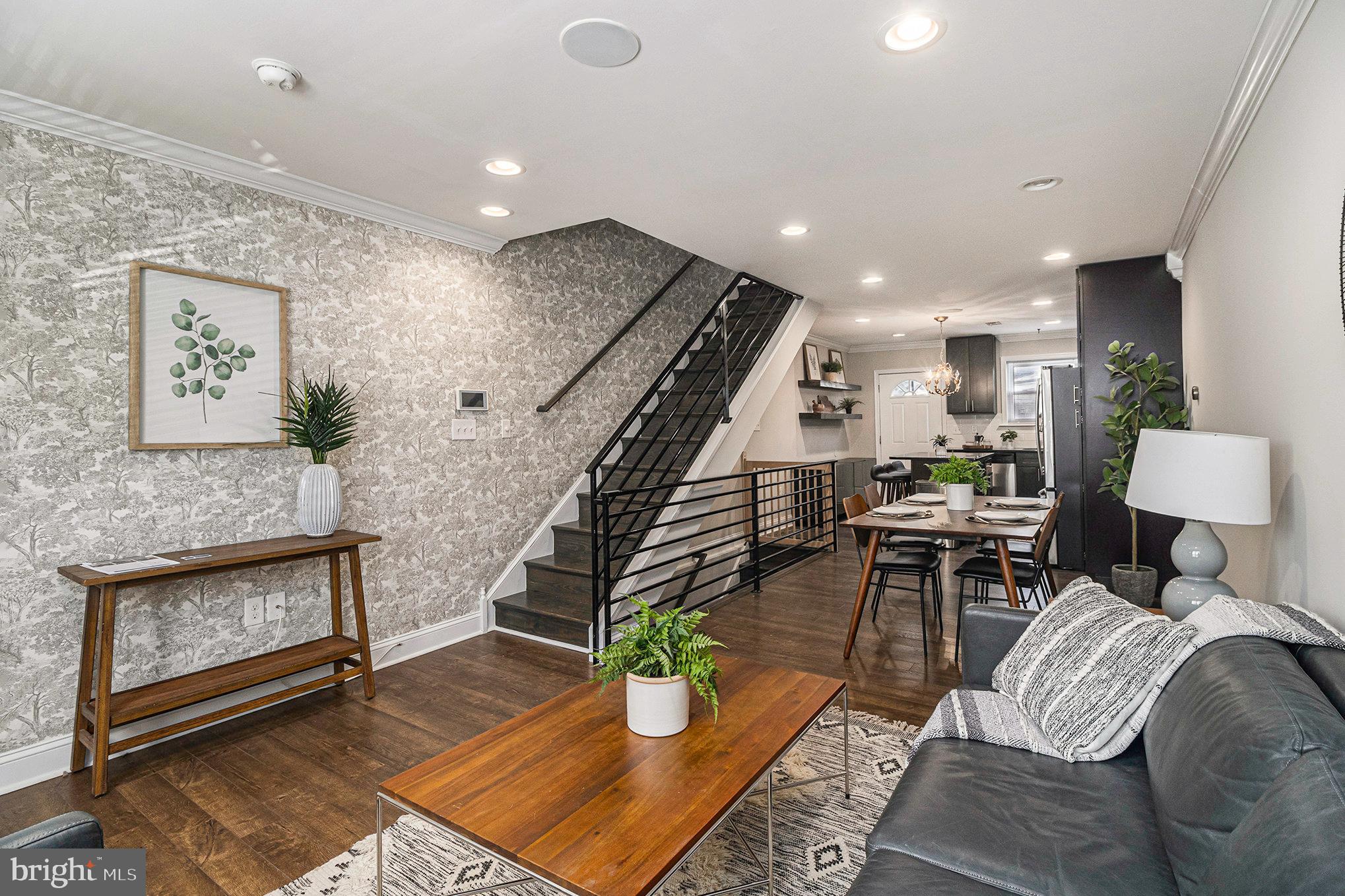 OPEN HOUSE Saturday 1/6 from 12-2pm!  Ready to sell!  Interest rate incentive available - In the first year, the interest rate will be 1% lower than the market rate for qualified buyers of this home!  Amazing opportunity to own a 3 Bed / 2 Bath townhome built in 2015 with a tax abatement through 2027 in Point Breeze just a short walk to the Broad Street Train Line and East Passyunk!  The exterior of this home features a classic brick facade with contemporary steel siding.  The first floor is ideal for entertaining guests with an open floor plan including a comfortable living room, separate dining area, and a spectacular kitchen!  The kitchen features an island with seating for two and additional storage with a decorative chandelier above, granite countertops, a modern white subway tile backsplash, custom oversized Espresso Shaker cabinets that extend to the ceiling offering plenty of storage, pantry cabinets, reclaimed wood-style floating shelves, and stainless steel appliances including a range, dishwasher, refrigerator, and built-in microwave.  Beyond the kitchen is a door that leads to the private and fenced large back patio area - great for your morning coffee, evening cocktail, or anytime outdoor entertaining!  Other features of the first floor include wide-plank engineered hardwood flooring (also found throughout the home), a built-in speaker system throughout, recessed lighting, gorgeous crown molding, contemporary black metal railings, and a beautiful accent wall in the living room that leads up to the second floor.  The second floor includes recessed lighting throughout, 2 nice-sized bedrooms, and a full bathroom with a barn door and marble-style tile on the floor, walls, and tub surround.  On the third floor, you will find the main ensuite bedroom with a stunning dark-stained wood accent wall, built-in speakers, recessed lighting, a walk-in closet, and your very own private balcony with an amazing view of Center City, Philadelphia!  The ensuite bathroom has matching floor-to-ceiling marble-style tile and an elegant frameless glass shower.  The fully finished basement has recessed lighting, wood-style tile flooring, and a laundry area/storage room with connections for a washer and dryer.   This home has a Nest Thermostat and is wired for two Nest security cameras and Xfinity Home security.  This location can’t be beat!  Just a short walk to East Passyunk and the Tasker Morris Station and minutes away from Washington Avenue shopping including Target, Sprouts, Starbucks, and the soon-to-be-opening Giant. Come see this outstanding home and schedule your showing today!  Details about the mortgage interest rate incentive can be provided upon request by the listing agent.