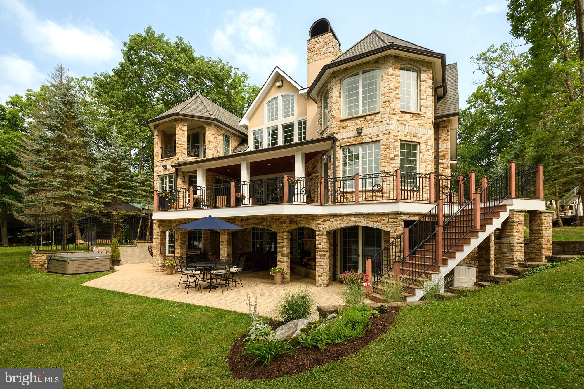 This extraordinary lakefront gem will truly take your breath away from the moment you pull in. The maintenance free stone and stucco exterior offers beauty while requiring very little upkeep. Upon entering the home, you will see that no detail was left undone. The stunning floor-to-ceiling stone fireplace, beautiful kitchen with an impressive island, granite counters, and a Viking gas range make the kitchen area every chef's dream.  Two staircases or an elevator allow you easy access to the upper or lower level. The upstairs space includes a great loft, gorgeous master suite with a gas wall fireplace, private balcony, stunning master bath and an oversized walk-in closet. The lower level is the perfect area for enjoying time with family and friends, boasting another living room with a fireplace, bar area, pool table, workout room and a sauna. The lakeviews from almost every room are just one more great feature this home has to offer. The attached four car garage with work space has a carriage house above it, providing an additional living area. If all this isn't enough, walk outside to a lakefront deck, patio, hot tub and two outdoor fireplaces. The home also offers a type A dock slip, level front yard and views for miles!! The home is also in close proximity to activities, restaurants and entertainment. This lakefront masterpiece will not last long, call today for a preview!