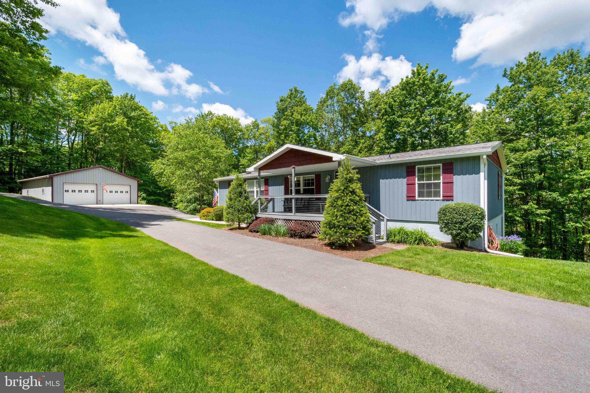 Tucked away on a quiet cul-de-sac in the desirable Royal Charlotte community, this stunning 4-bedroom, 3-bathroom home is the kind of property you'll fall in love with the moment you arrive. Surrounded by the beauty and tranquility of the mountains and accessed by county-maintained roads, this impeccably maintained home showcases pride of ownership throughout. From the expansive Trex decking that wraps around much of the home and the welcoming covered front porch to the thoughtfully updated interior, every detail has been designed for comfort and enjoyment. The home features luxury vinyl plank flooring, carpet tile flooring, beautifully tiled bathrooms, granite countertops in the kitchen and all three bathrooms, heated tile floors in the master bathroom and lower-level bathroom, and spacious living areas perfect for gathering with family and friends. Major upgrades include new siding, new gutters with covers, a tankless hot water heater, whole-house generator, heat pump with gas backup, new sliding glass doors, drywall, and a freshly painted foundation. Outside, you'll find a paved driveway, an impressive 30x40 garage, and a 16X50 pole barn with electric, providing ample space for vehicles, storage, hobbies, and outdoor equipment. Adding to the property's charm are mature plum, pear, apple, and peach trees, providing seasonal blooms, fresh fruit, and a touch of country living right in your own yard. Whether you're unwinding in the hot tub, entertaining on the deck, or simply enjoying the peaceful setting, this home offers the perfect blend of modern convenience, quality craftsmanship, and mountain charm. Properties this well cared for are rare, and one visit is all it takes to see why this exceptional home stands out from the rest. Call today!