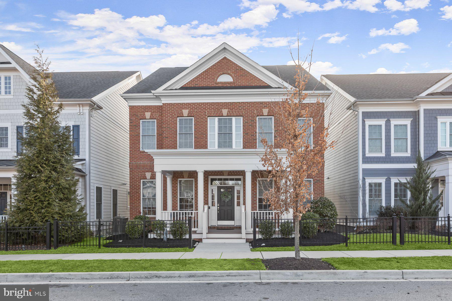 Welcome home to 11446 Dairy Street located in Maple Lawn’s highly coveted Garden District. This Bristol floor plan by luxury home builder Michael Harris Homes is not to be missed. Buiit in 2017, this 5 bedroom, 4.5 bathroom beauty boats more than 5,000 square feet of luxury living space every inch of which has been maintained to perfection. The large covered front porch welcomes you inside the main level where 10’ ceilings immediately impress. Gleaming hardwood floors are found throughout the main level as well as 3-piece crown moulding and updated designer light fixtures.  The living room features a gas fireplace, custom built-ins, and an entire wall of floor-to-ceiling windows flooding the home with natural light. The gourmet kitchen offers 42” two-tone cabinetry, granite countertops, a double oven, a 5-burner cooktop, a stylish beveled subway tile backsplash and a large center island. The eat-in area just off the kitchen allows access to the custom backyard patio. A spacious main-level office featuring French doors, a half bath and a butler pantry complete the main level. 

The upper level presents more hardwood flooring on the landing and in the primary bedroom and another designer chandelier. The primary bedroom has a spacious sitting area and dual walk-in closets. The primary bathroom features a dual sink vanity, large shower stall and garden tub. A guest suite with en suite bathroom, two additional bedrooms with brand new carpet and a shared bathroom and a spacious laundry closest are also found upstairs. The lower level provides a sprawling recreation room with luxury vinyl plank flooring and recessed lighting, a large guest bedroom with even more brand new carpet and a spacious closet, another full bathroom and two large unfinished storage areas. Conveniently located close to all major Baltimore/DC commuter routes, and with enviable amenities including a resort-style community pool, tennis courts, pickleball courts, basketball courts, state-of-the-art gym and more, you’ll quickly see why Maple Lawn is one of the most sought-after communities in the region. Hurry! 11446 Dairy Street won’t last long.