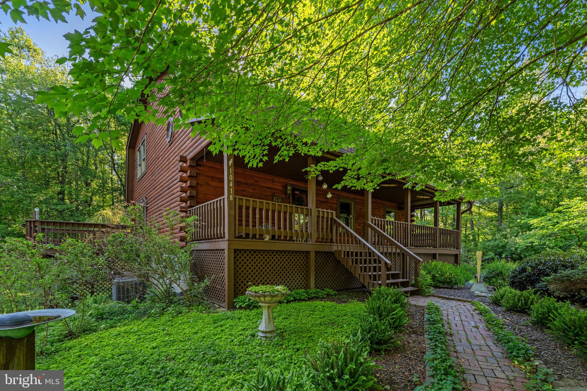HUGE Price Reduction! Incredible value now listed at $725,000.00! Nestled on a serene 8.16-acre lot, this charming log home offers a perfect blend of rustic elegance and modern comfort. Built in 1994 and thoughtfully renovated in 2014, the property boasts 2,973 sq. ft. of meticulously maintained living space. Step inside to discover an inviting open floor plan adorned with exposed beams and warm hardwood floors, creating a cozy atmosphere throughout. The heart of the home features a spacious eat-in kitchen equipped with stainless steel appliances, upgraded countertops, and a delightful breakfast area. The family room, conveniently located off the kitchen, is perfect for gatherings, while the primary suite offers a luxurious bath with a walk-in shower and soaking tub. The fully finished daylight basement provides additional living space, complete with a second kitchen and walkout access, ideal for entertaining or accommodating guests. Enjoy evenings by the free-standing wood fireplace, adding warmth and charm to your living space. Outside, extensive hardscaping complements the lush landscaping, while a deck and porch invite you to relax and soak in the picturesque views of the surrounding trees and creek. The property is private and secluded, offering a peaceful retreat from the hustle and bustle of everyday life. Conveniently located in a rural setting, this home features a detached garage and ample parking. Experience the tranquility of nature while being just a short drive from local amenities. This is more than a home; it's a lifestyle waiting for you to embrace.