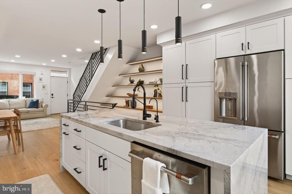 4-bedroom, 2.5-bath home with OFF-STREET PARKING, a private roof deck, Finnish sauna in the heart of Graduate Hospital on a tree-lined street. This 2,441 SF home features wide-plank European White Oak floors, a custom kitchen with GE Café appliances, and 6 Amish-sourced white oak floating shelves with integrated LED lighting, including one spanning 14 feet floor to ceiling. Matching white oak continues as a custom railing topper from basement to pilot house.

The 3rd floor primary suite is a full-floor retreat with south-facing windows, a freestanding soaking tub, walk-in shower with bench, NuHeat heated floors, and an Elfa-fitted walk-in closet. Above, a proper pilot house leads to a private roof deck with panoramic Center City skyline views.

The 2nd floor offers 2 bedrooms, a full bath, and laundry. Smart upgrades include Lutron Caséta switches and blackout shades, Nest thermostats & a Nest doorbell.

The finished lower level adds exceptional flexibility with a traditional Finnish sauna vented outside, exercise room, powder room, & a 4th bedroom or office with egress window. NuHeat radiant heated floors run throughout.

5 YEARS OF TAX ABATEMENT REMAINING. All new systems, renovated 2020. OFF-STREET PARKING. Marian Anderson catchment. Walk to Sabrina's, Ants Pants, City Fitness, Heirloom Market, Dock Street, and Ultimo Coffee. Minutes to Penn, HUP, CHOP, & Rittenhouse Square.
