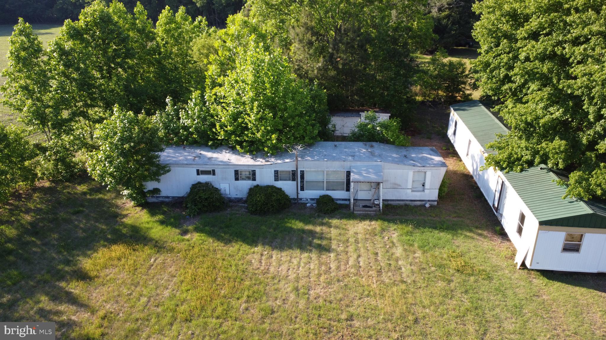 Situated on approximately 1.13 acres in a peaceful country setting, this property offers a unique opportunity for investors, renovators, or buyers seeking a rural homesite. The property includes two manufactured homes, an existing well, and a septic system. Surrounded by farmland and mature trees, the lot provides privacy and open space while remaining conveniently located near Delmar, Laurel, and Salisbury. Property is being sold as-is. Condition of improvements is unknown. Buyers should conduct their own inspections and due diligence.