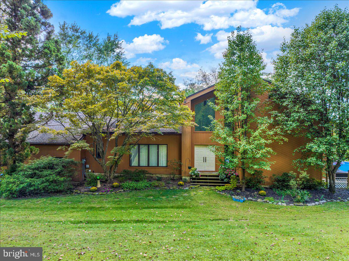 OPEN HOUSE Sunday June 7th from 11am-1pm! SECOND CHANCE OPPORTUNITY! Due to buyer's financing falling through this amazing property is BACK ON THE MARKET!
Tucked away on 11 private, wooded acres, this stunning 4-bedroom contemporary home is a rare retreat where modern design meets nature’s tranquility. With soaring vaulted ceilings, clean architectural lines, and expansive windows throughout, every room is bathed in natural light and offers sweeping views of the surrounding landscape.

The heart of the home features a dramatic two-story stone fireplace that anchors the spacious living area, perfect for cozy evenings or entertaining guests. Flowing seamlessly from indoors to out, the 
open-concept layout leads to a beautifully updated kitchen, dining area, and multiple access points to the expansive deck and pool.  

Step outside to your personal oasis: a sparkling in-ground pool surrounded by an oversized deck ideal for lounging, dining, and summer gatherings. Whether you're enjoying quiet mornings with coffee or hosting weekend get-togethers, the outdoor space is designed for relaxation and connection.

The home offers four generously sized bedrooms, including a serene primary suite with treetop views and spa-inspired ensuite. With plenty of room for a home office, guest accommodations, or creative studio, this property is as versatile as it is beautiful.

Located just minutes from town yet worlds away from the hustle, this is your chance to own a peaceful, contemporary sanctuary with unmatched privacy and timeless style. 1 year home warranty included with an acceptable agreement. OPEN HOUSE Thursday, May 28th from 5pm-7pm!