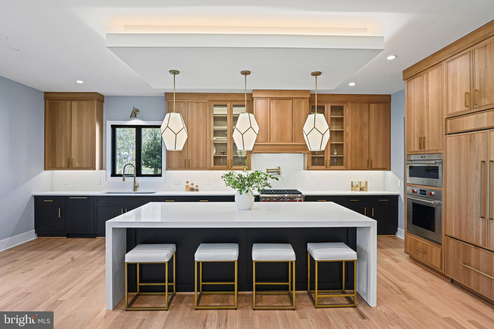 NEW PRICE, EXCELLENT QUALITY AND VALUE! Welcome to 1052 Balls Hill Road, a thoughtfully designed modern contemporary offering nearly 9,000 square feet of living space in the heart of McLean. With 6 bedrooms, 6 full and 2 half baths, this home delivers style and convenience at every turn.

Inside, you’re greeted by soaring 10-foot ceilings, wide-plank hardwood floors, and a striking floating staircase. The main level features an open, light-filled living room that flows effortlessly into the dining area, ideal for both everyday living and entertaining. The chefs kitchen is a true centerpiece, complete with custom cabinetry, soft-close drawers, a waterfall quartz island, Sub-Zero and Wolf appliances, and a separate prep kitchen with an oversized pantry. A secondary main-level suite offers a full bath, walk-in closet, and bedroom, perfect for guests or multigenerational living. A gas fireplace anchors the family room, which opens to a rear deck, perfect for indoor-outdoor gatherings. 

Upstairs, a luxurious primary suite with an electric fireplace and spa-inspired bath, along with three additional bedrooms, each with en-suite baths. A laundry room on this floor with washer/dry hookups adds convenience for every day living. 

The walkout lower level is designed for both relaxation and entertainment, featuring a gym, movie theater, wet bar, gas fireplace, plus an additional bedroom and full bath. Step outside to a covered stone patio for seamless indoor-outdoor living.

Additional highlights include elevator readiness, a 3-car garage with epoxy flooring and EV charger capability, Trex decking, Pella windows and doors, and LED lighting throughout.

1052 Balls Hill Road is a rare turnkey opportunity in one of McLean’s most desirable locations. Reach out to Emily Clark to schedule a showing!