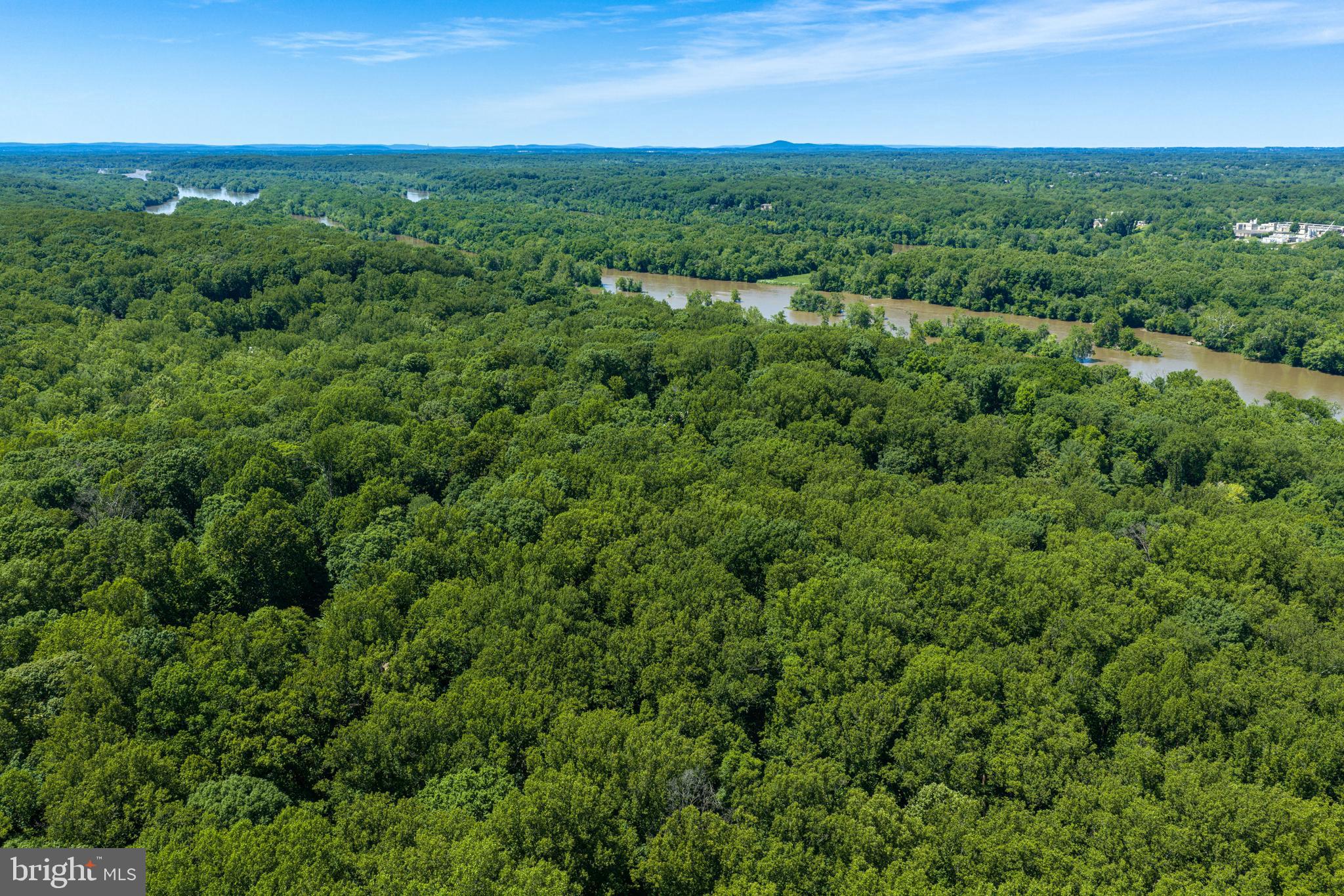 Nestled on five breathtaking acres bordering the  River Bend Park, this extraordinary homesite offers a rare blend of privacy, natural beauty, and endless potential. Surrounded by mature trees and seasonal carpets of vibrant bluebells, the property feels like a private retreat immersed in nature. Scenic park trails lead directly to the Potomac River, inviting peaceful walks, kayaking adventures, and year-round outdoor enjoyment just beyond your doorstep.

Perched high on a gentle hilltop, the parcel is perfectly positioned to capture sweeping panoramic views and unforgettable sunsets. The serene setting provides the ideal backdrop for building a dream home designed to embrace the surrounding landscape and tranquility. With abundant space, exceptional privacy, and direct access to protected parkland, this is a once-in-a-lifetime opportunity to create a truly spectacular estate in an unparalleled natural setting.