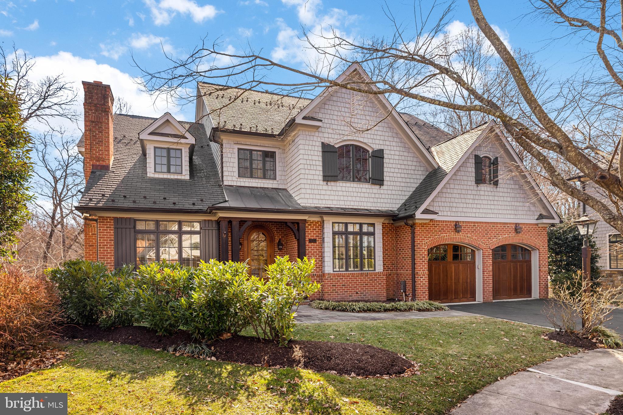 Stately, expansive, & turnkey home with ELEVATOR to all floors just minutes from Chain Bridge/DC! Located in a private cul-de-sac (with great playspace and ample guest parking!) the home features beautiful, serene woodland views through countless large windows and multiple lovely porches. Main level has 10' ceilings and features formal living and dining rooms, study, elegant kitchen with breakfast area, large adjoining family room, and mud room leading to 2-car attached garage. Upstairs are 5 bedrooms, each with ample closet space and en suite bath, including a generous primary suite with fireplace, private terrace, and dressing room; as well as a laundry room and open sitting room/flex space on the 3rd floor. The lower level features a bedroom with en suite bath, exercise room, and spacious rec/family space and storage.