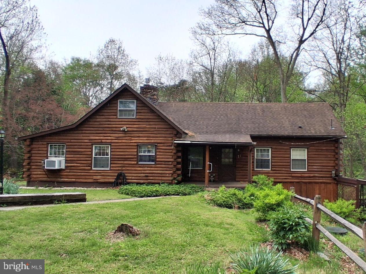 Welcome to 305 Hanna Kurtz Road, a secluded log home with a 20 x 40 pole building/3 car garage on a wooded lot. , 1st floor bedroom with walk in closet and a 1st floor bath.  Cathedral  ceiling  in living room with a a stone fireplace and a propane insert .Loft overlooks the living room, 2 rooms up stairs could be used as bedrooms. Partially finished walk out basement with a dry bar, wrap around deck and 2 porches .
Showings start on June 30th .