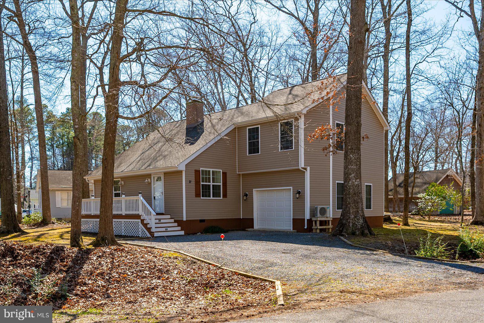 PRICED TO SELL - Welcome to this inviting cottage-style home nestled in the South Gate section of Ocean Pines. Thoughtfully renovated in 2016, this property features a new roof, windows, flooring, updated kitchen and baths, stainless steel appliances, heat pump, exterior siding, decks, and a screened porch. The living room is highlighted by a soaring vaulted ceiling accented with beautiful stained tongue-and-groove wood, creating a warm and airy atmosphere. The kitchen is well designed with generous counter space, a breakfast bar, and a spacious pantry. In 2017, the home was expanded to include a garage and a second-floor primary suite complete with a walk in closet and a private en-suite bath. Situated on a large corner lot, the property offers ample outdoor space to relax or entertain, with both a welcoming front porch and a screened rear porch. Enjoy all that Ocean Pines has to offer, including outdoor pools, a year-round indoor pool, tennis and pickleball courts, basketball courts, golf course, recreation and community center, marina, yacht club, boat ramp, and the Ocean City Beach Club with parking at 50th Street. This is a wonderful opportunity to own a home that combines charm, updates, and exceptional community amenities.