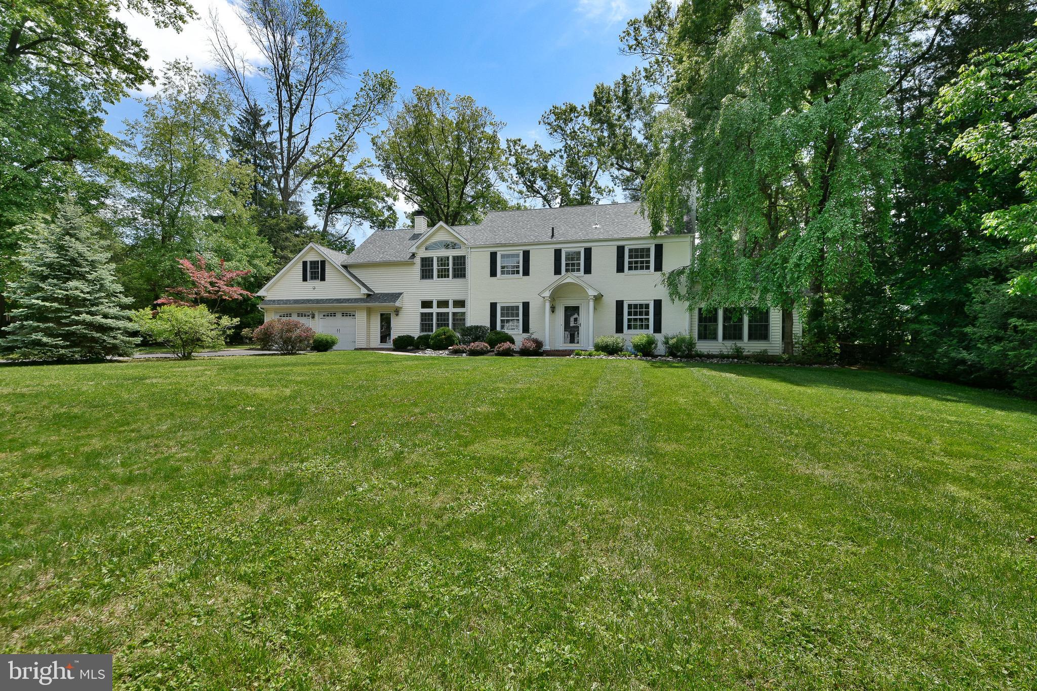 Nestled on a beautifully landscaped ¾-acre lot in highly desirable Lower Makefield, this exceptional Colonial offers an expansive living space with timeless elegance and extensive updates throughout. A private driveway lined with mature perennial gardens leads to the stately exterior, an oversized two-car garage, and a charming brick walkway, creating unforgettable curb appeal from the moment you arrive. Inside, newly refinished ¾-inch solid oak hardwood flooring flows seamlessly throughout the home, complementing the architectural details found in every room. The welcoming foyer opens to the elegant dining room, and a sophisticated billiards room, which is highlighted by a striking double-sided gas fireplace. Designed for both entertaining and everyday living, the main level showcases soaring vaulted and 9-foot ceilings, exposed brick accent walls, custom built-ins, and arched transom windows. Natural light flows in from the walls of windows and the two sets of sliding glass doors that overlook the picturesque grounds. At the center of the home is the stunning, updated kitchen featuring a large center island with ample seating and a prep sink, quartz countertops, abundant hardwood cabinetry, and a walk-in pantry. A premium suite of brand-new SKS Signature Kitchen Suite stainless steel appliances includes a built-in refrigerator, gas cooktop with range hood, double wall ovens, built-in dishwasher, and a beverage refrigerator. New lighting, sinks, and faucets complete this beautifully renovated space, which opens seamlessly to the breakfast room. Just beyond the kitchen is the expansive family room featuring 9-foot ceilings, a brick surround gas fireplace, built-in shelving, and sliding glass doors that lead to the fenced backyard and brick patio - perfect for entertaining, outdoor play, or relaxing around the firepit. A mudroom and full bathroom offer excellent potential for an in-law or guest suite. On the opposite end of this home, a spacious family room offers warmth and character with an exposed brick accent wall and a dramatic wall of windows topped by an arched transom window, filling the space with natural light and seamlessly bringing the outdoors in. Upstairs, you’ll find five spacious bedrooms and three full bathrooms, including the luxurious primary suite with vaulted ceilings, a custom walk-in closet, and a spa-inspired en-suite bath featuring a new double vanity sink, updated fixtures and lighting, an oversized shower, and a jetted soaking tub. The finished bonus room above the garage includes hardwood flooring, heating and air conditioning, offering exceptional flexibility as a home office, gym, guest suite, or playroom. The partially finished basement provides additional living and storage space, while the expansive fenced backyard and brick patios create a private outdoor retreat. Additional recent improvements include a beautifully renovated main floor powder room, refurbished plumbing beneath the kitchen, a brand-new second-floor LG washer and dryer, recessed lighting throughout, and refinished oak hardwood flooring throughout the entire home. Ideally located just moments from the scenic Delaware Canal walking paths, this remarkable property combines elegance, comfort, and modern upgrades in one of Lower Makefield’s most sought-after settings.