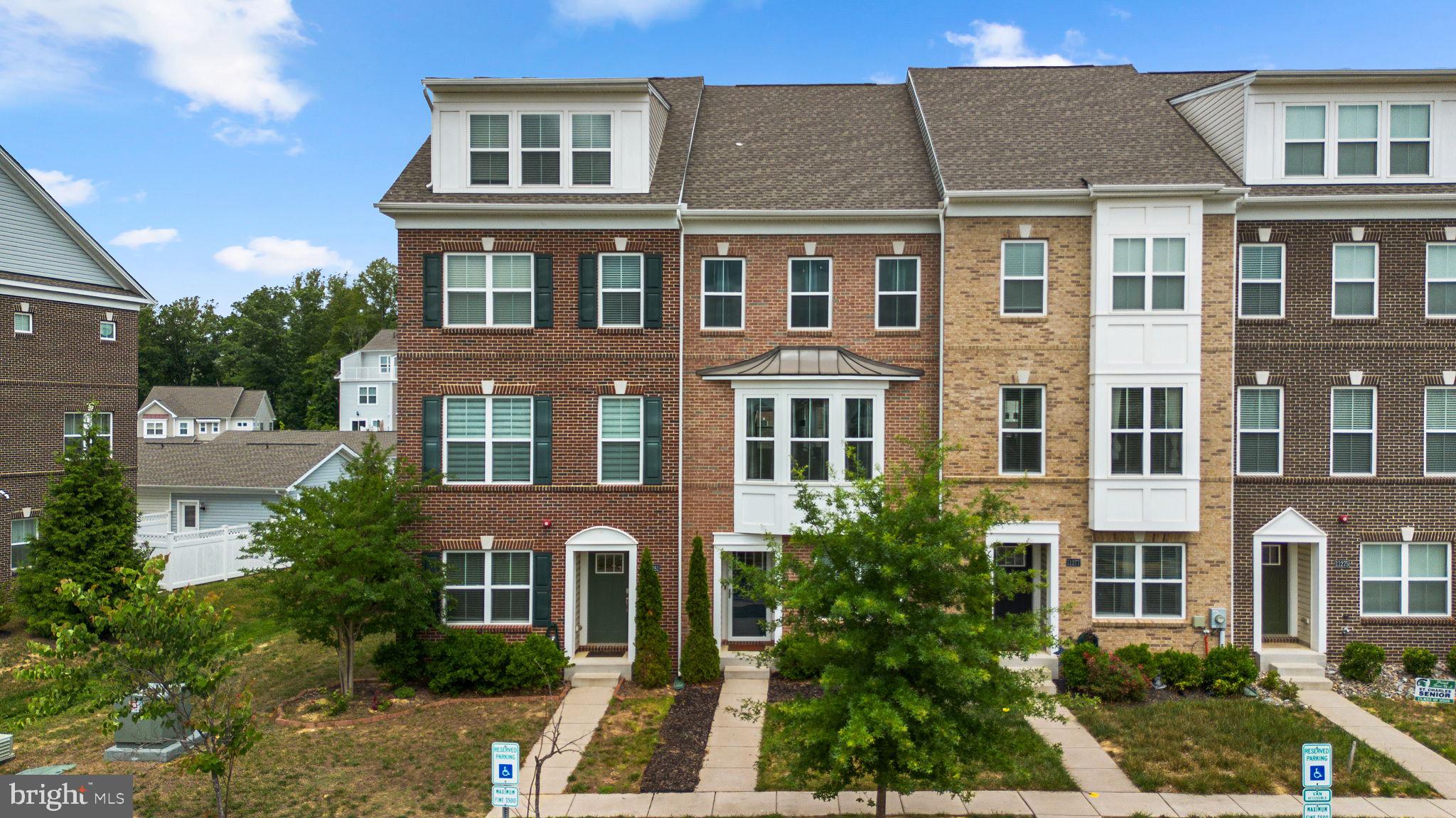 Beautifully maintained 3 level townhome in one of White Plains' most sought after communities. Built in 2019, this 2,200 square foot home features hardwood floors, an entry level in-law suite with full en suite bath, entertainment room, patio, and two car garage. The main level offers an open concept living, dining, and kitchen layout anchored by a large granite island, plus a private deck perfect for entertaining. Upstairs you will find two bedrooms each with their own en suite bath, including an owner's suite with dual closets. Minutes from National Harbor, Washington DC, Northern Virginia, and top dining and entertainment. This one will not last!