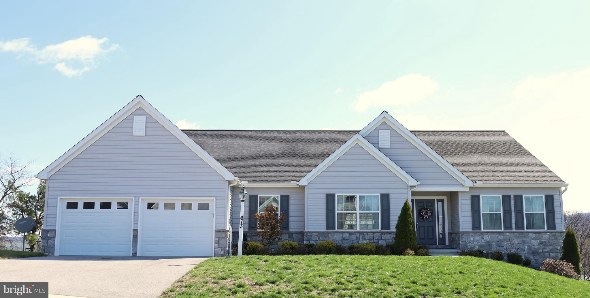 Nestled in the serene Eagles View community, this charming well maintained 3BR, 2BA Wellington Rancher, built in 2021, offers a perfect blend of modern comfort and inviting warmth. Spanning 2,398 sq ft, the open floor plan seamlessly connects the family room to the eat-in kitchen, making it ideal for gatherings. Situated on a premium, beautifully landscaped 0.29-acre lot backing to open space, this home features an open floor plan with hardwood flooring, a cathedral ceiling in the family room, and a seamless flow into the gourmet kitchen with granite countertops, island, pantry, and breakfast area—perfect for everyday living and entertaining.
The split-bedroom layout provides privacy, with a spacious primary suite offering a walk-in closet and a luxurious en-suite bath with double vanity and tiled walk-in shower. Two additional bedrooms and a full bath are thoughtfully positioned on the opposite side. Additional highlights include main-level laundry, recessed lighting, ceiling fans, under-cabinet lighting, humidifier, electronic air filter, and numerous upgrades throughout.
Enjoy outdoor living on the deck overlooking the backyard and scenic views. The full unfinished walkout basement with Superior Walls offers endless potential for future living space. Complete with a 2-car garage featuring an epoxy floor and laundry tub, ample driveway parking, and modern systems for comfort and peace of mind—this home offers the perfect blend of style, space, and convenience.