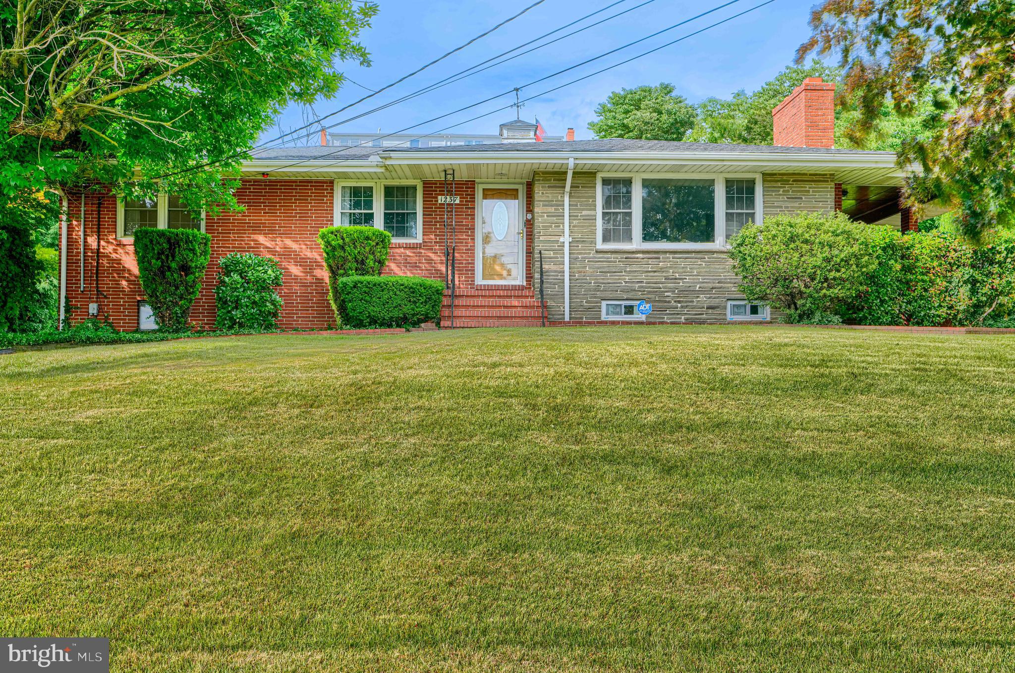 Welcome home to this beautifully renovated brick rancher offering 4 bedrooms, 3 full baths, and an abundance of living space. Step inside to a warm and inviting living room featuring gleaming hardwood floors and a classic fireplace. The stunning new kitchen is the heart of the home, showcasing two-tone cabinetry, quartz countertops, and stainless steel appliances. Just beyond the kitchen, glass doors open to a spacious family room addition complete with a skylight, a second fireplace, a beautiful bow window, and access to a cozy covered side porch.

The main level also features a private primary suite with its own renovated full bath, along with two additional bedrooms, all with hardwood flooring. The finished lower level offers exceptional flexibility with a fourth bedroom, full bath, and a large family room with a third fireplace, making it an ideal setup for guests, extended family, or a potential in-law suite. Convenient access to the attached two-car garage is available from the basement. Additional updates include a new roof and HVAC system, providing peace of mind for years to come.