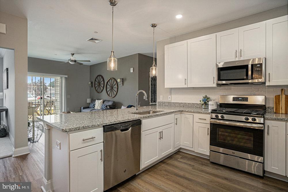 The MODEL at  The Residences at Brookhaven Glen,  Delaware County is now available, and this one has all the bells and whistles!! Walk into the lobby where there is a spacious seating area as well as an elevator. Step into the condo where an entry foyer with an open floor plan and a gorgeous white kitchen with 42" upgraded cabinets greet you. A stainless steel undermount sink, granite counter tops, white ceramic tile backsplash and stainless steel GE appliances (including the refrigerator too) as well as an upgraded faucet and pendant lighting are all a part of this beautiful kitchen.  Crown and chair rail are included in the adjacent dining area.  This home is a 2 bedroom unit with a den (or could be a possible 3rd bedroom). The living area is beautiful and has sliders to a lovely patio.   Beautiful 9 foot dramatic ceilings make this floor plan seem even more spacious. There are raised panel doors throughout with custom hardware, vinyl plank flooring in foyer, living room, dining area, and kitchen and stain-resistant carpeting is in the den/bedrooms. "Progress Lighting" lighting package in foyer/dining area/kitchen.  A full size washer and dryer are also included. The main bedroom suite includes a walk-in closet and an incredible, mega-upgraded full bathroom with gorgeous customized shower with beautiful tile, upgraded full glass doors, quartz countertops and a ceramic tile floor too. The model includes lighted ceilings fans in all the rooms too. The full hall bath features a large stall shower as well as a granite countertop.  All furnishings are included too! The on-site amenities include a private dog park, gorgeous courtyard with lovely landscaping includes water fountain and gazebo (with rocking chairs for your relaxation) and  2 pergolas with natural gas grills for your grilling pleasure.  This home is ADA accessible and conveniently located just minutes from  I-95, Route 1, the Blue Route, Media boro, the airport and lots of shopping and restaurants!  This is the last unit and it has only become available due to buyers home sale contingency falling thru. Come see! You won't be disappointed! Beautiful community, lovely grounds!   *Community currently under the 80/20 rule, so these homes are also available to residents over the age of 18. 
(MANY homeowners have appealed their taxes after move-in and have had them successfully reduced)
