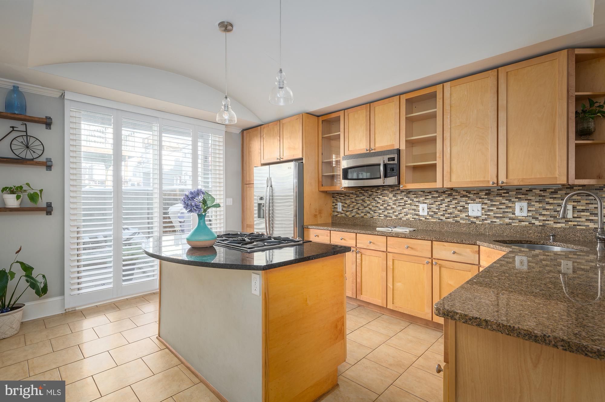 Beautifully renovated contemporary home, with over 2500 sqft of living space. The house welcomes you into a light-filled living room with custom ceilings, a gas fireplace and solid wood floors, leading you into a super wide separate dining room and a large eat-in kitchen with beautiful maple wood custom cabinets, granite counters and stainless steel appliances. Large sliding doors with plantation shutters will lead you into your own zen patio perfect for cookouts and gatherings. Second level offers two large rooms, including a master suite with custom built-ins and its own private balcony, large closets, designer Mediterranean-style bathrooms, as well as an interior access to the dual rooftop deck overlooking city views. Lower level offers its own guest suite with a separate bathroom, perfect also for roommates. This home is located steps away from Canton Square, close to Patterson Park, Fells Point, Harbor East, as well as John Hopkins and all major highways.