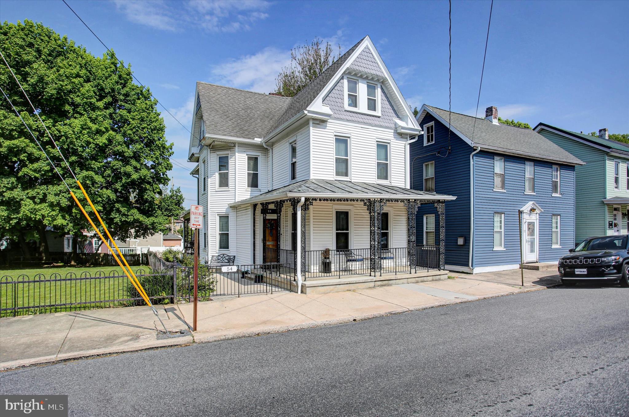 With its great location on Clayton Ave, this spacious Victorian home is sure to meet all your needs.  Aesthetically, the home still captures the 1930s era with arched entryways, tall ceilings, hardwoods, original trim work, and more. However, this home also offers modern conveniences like central air conditioning, updated vinyl windows, 200amp breaker box, and more.  Offering over 2500 finished sq ft above grade and a couple finished sq ft below grade too, there is plenty of room for everyone to spread out and enjoy their own spaces! The main level features a foyer entryway, living room, siting room, dining room, kitchen, laundry room with pantry space, and half bath.  Hardwood floors run beneath the blue carpet in the living room.  Upstairs you will find 3 bedrooms and 1 full bath.  Each room has its own closet or two and there is a darling balcony off the smallest bedroom.  The attic space has been converted into another bedroom with a full closet.  There are two large walk in storage areas still offered on either end of the attic as well. The basement holds the utilities but also has a finished room with closet, plenty of storage shelving, and a workshop space that doesn't even feel like you're in a basement since there are full size windows and a standard door that exits into the fenced rear yard.  Outside there is a covered porch, decorative fencing out front to maintain the Victorian appeal, and privacy fencing in the rear.  At the back of the property is a one car garage and your own private parking area for additional vehicles accessed from the alley. Schedule your tour today!