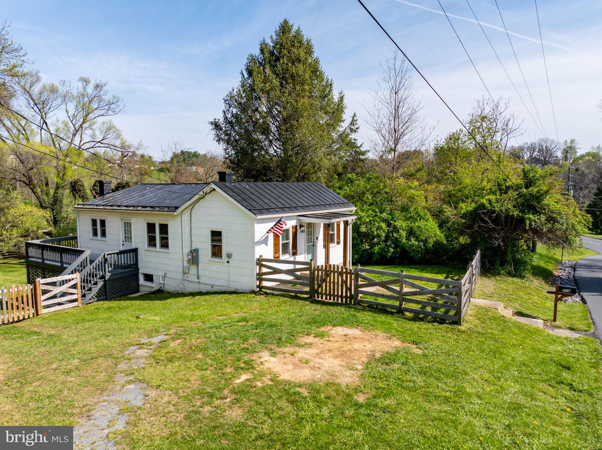 Welcome to 714 Ox Rd., where charm, convenience, and comfort come together near the heart of Woodstock. Lovingly updated in 2022, this delightful home sits on nearly an acre of land with a fully fenced front and back yard—perfect for pets, play, and peaceful privacy.

From the moment you arrive, the inviting curb appeal draws you in with its quaint character and traditional design. Inside, you’ll find a bright and spacious living room that sets the tone for relaxed everyday living. The thoughtful layout includes two cozy bedrooms and one full bathroom—ideal for a first-time homebuyer or someone looking to downsize without sacrificing space.

Enjoy meals in the dedicated dining room and whip up your favorites in the updated kitchen. Step out onto the wrap-around back deck, perfect for entertaining or simply enjoying your morning coffee while overlooking the tree-lined backyard.

A full unfinished basement offers abundant storage. Just minutes from schools, parks, shopping, and restaurants, this home blends small-town warmth with everyday convenience.