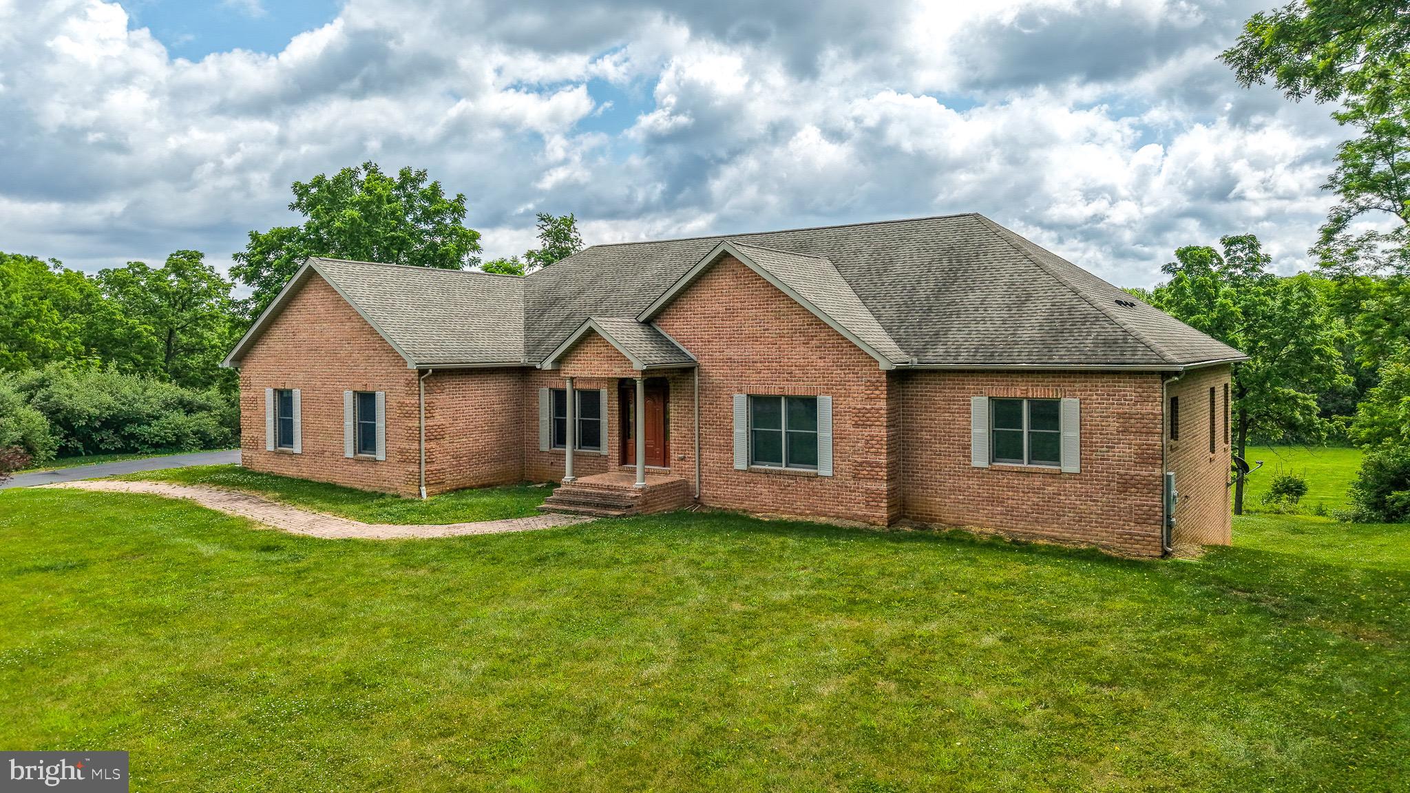 I promise you will not want to miss this one.  Costume built all brick rancher in a private setting but only minutes to town.  Beautiful hardwood floors throughout the home and all cabinetry in the house custom made to match.  Large kitchen with an island and all granite counters in the kitchen and baths.  Gas stove, butler's pantry and additional walk in pantry add to this delightful kitchen.  Large eating are off the kitchen with large windows overlooking the beautiful, large back yard.  Separate dining room for formal dining room is perfect for entertaining.  Kitchen overlooks the large family room with a gas fireplace.  Large primary bedroom with many windows giving the room much natural light in addition to two walk in closets. Primary bath has double sinks and many cabinets for storage.  Large soaking tub and a huge walk in tiled shower.  Three more bedroom and two bathrooms on the main level.  The basement is massive and has had some improvements made.  A perfect layout for an in-law suite with a rough in for a full bath, plumbing for a kitchen and an area for a washer  and dryer.  Three car garage, geo-thermal heating and cooling and attention to detail are just some of the many details of this property that you do not want to miss.