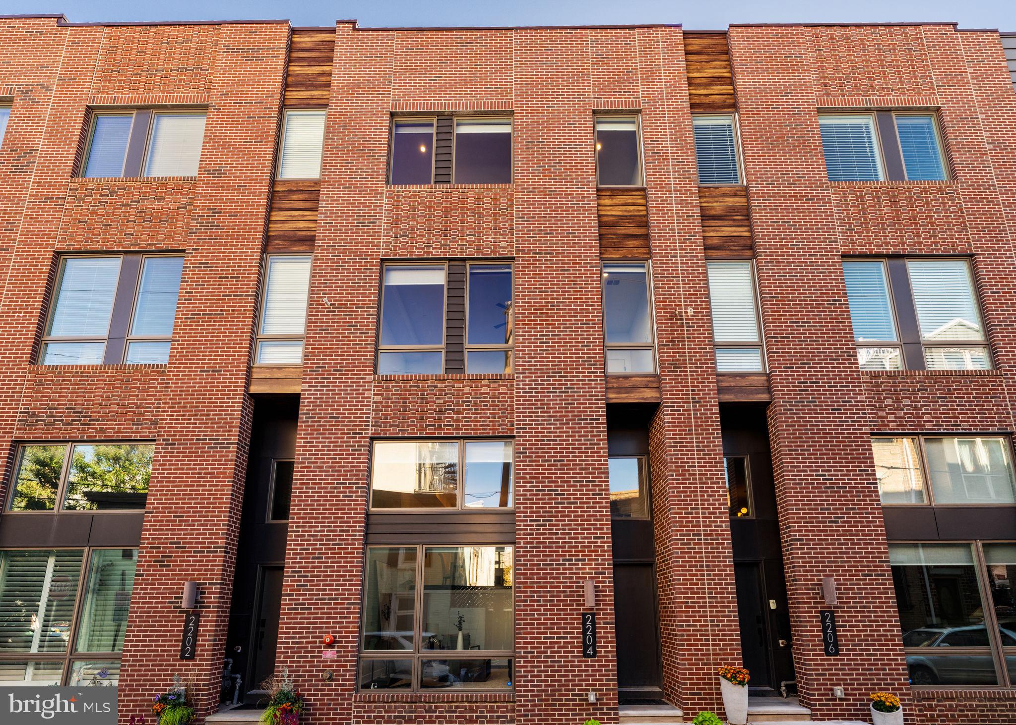 Welcome to 2204 League St - an elegant residence in the heart of the vibrant Graduate Hospital neighborhood offering 4 bedrooms and 3.5 bathrooms, 2 car parking, a finished basement, and 2 outdoor spaces including a roof deck with gorgeous views of the city. This home is also located in the Marian Anderson Neighborhood Academy catchment (formerly Chester Arthur). There are also 5 years remaining on the tax abatement!

As you approach, the home's striking façade and expansive front windows greet you, hinting at the abundant natural light within. Step inside to discover soaring 15-foot ceilings in the living room, complemented by open stairs and a glass wall that seamlessly connects to the dining area, creating an unrivaled sense of openness.

The gourmet kitchen is a chef's dream, boasting an oversized quartz center island, ample cabinetry including a pantry, tile backsplash, and high-end stainless steel appliances. The adjoining deck, which extends 8 feet, is perfect for al fresco dining and gatherings.

The third floor hosts two well-sized bedrooms with custom closets, accompanied by a full bathroom featuring a tub-shower combo and double vanity. A convenient laundry room with cabinetry and sink completes this level.

Ascend to the fourth floor, where a wet bar, beverage fridge and ample storage await. This leads to the primary suite that can easily accommodate a king-sized bed and features oversized windows. There is an additional walk-in closet with a custom closet system and a luxurious bathroom with a double vanity, and walk-in shower. An additional bedroom offers flexibility for guests or an office.

The crowning jewel is the roof deck, offering panoramic cityscape views. The finished lower level serves as an ideal space for a den, playroom, or gym. With two-car parking, EV hookup, and ample storage, this property is an urban sanctuary.

Located near neighborhood favorites like Dock Street Brewery, Breezy's Deli, Porcos, Los Camaradas, The Sidecar Bar & Grille, and Sabrina’s Cafe. This home is also convenient to stores like Sprouts, CVS, Aldi, Target, Starbucks, and within walking distance to Center City.
