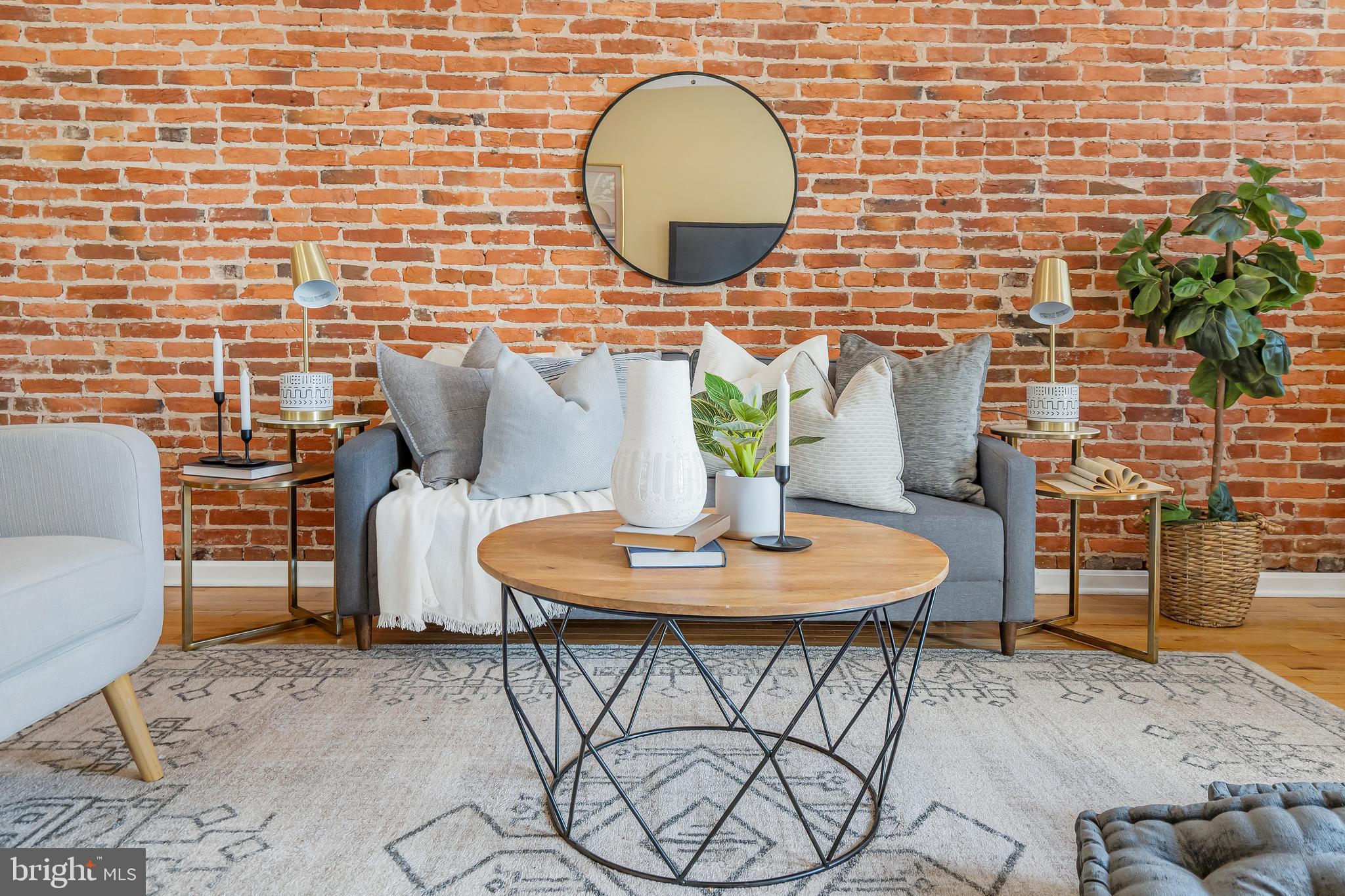 Nestled in the heart of Canton, this expansive and breathtaking end-of-group row house is a true gem, offering a wealth of amenities and an abundance of natural light. With approximately 1,850 square feet of living space, this home boasts three bedrooms and three-and-a-half bathrooms, providing ample room for comfortable living.

Upon entering the main floor, you'll be greeted by a primary bedroom complete with an en-suite bathroom, creating an oasis of relaxation and convenience. The main level also features an abundance of charm, highlighted by exposed brick walls that lend character to the space. Elegant details such as recessed lighting, crown molding, and chair rail further enhance the ambiance. The kitchen is a chef's dream, equipped with stainless steel appliances and granite countertops, offering both style and functionality. A beautifully tiled bath adds a touch of luxury to everyday living. The open chair staircase and decorative fireplace add to the overall allure of this residence.

As you ascend to the upper level, you'll discover two additional bedrooms, each showcasing exposed brick walls and a vaulted ceiling that creates an inviting and airy atmosphere. Tiled baths on this level maintain the home's commitment to quality and style. The real treasure awaits on the rooftop deck, where you can unwind and enjoy picturesque views of the surrounding area.

Conveniently located just 160 steps away from Canton Square, this property invites you to explore a vibrant neighborhood known for its bar hopping opportunities and fine dining experiences. For those who appreciate waterfront living, the Canton waterfront is a mere three blocks away, offering serene moments by the water's edge. Commuters will appreciate the home's proximity to major transportation arteries, including I-95 and I-895. Additionally, the esteemed Johns Hopkins University is just a short drive away, making this location ideal for professionals and students alike. Don't miss the chance to make this remarkable Canton residence your own.