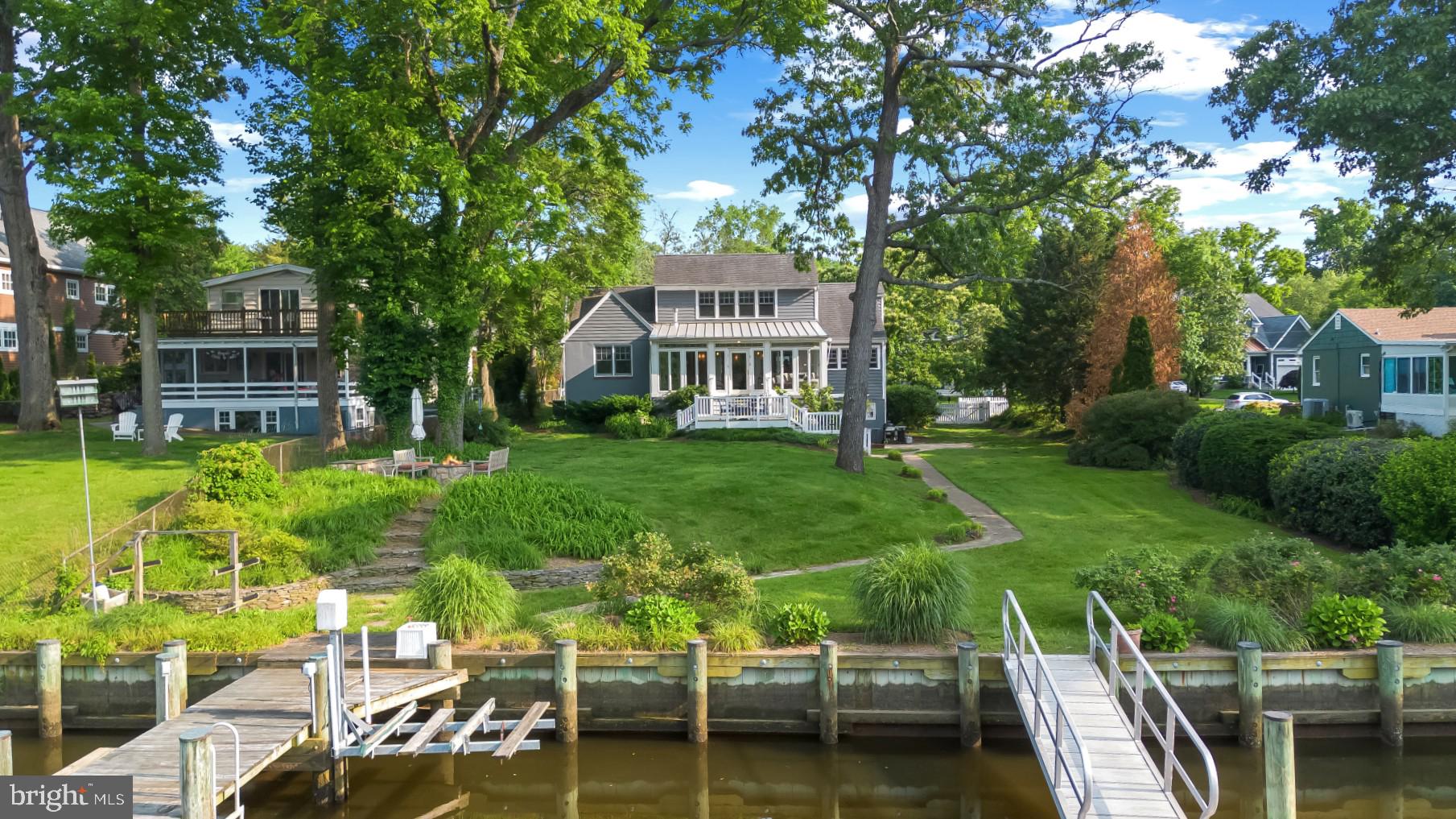 Celebrate the Eastport lifestyle in this captivating Craftsman-style waterfront home located in the Greenacres community. Now is the perfect time of year to enjoy everything the Annapolis/Eastport lifestyle has to offer and this home offers the ideal backdrop for those adventures! With 3 levels of well maintained and impeccable living space, there is plenty of room to entertain family and friends. Enjoy four bedrooms,  3 full baths, tons of natural light, fully- equipped gourmet kitchen, and spacious living room with fireplace. The open concept floor plan maximizes the water views with large windows and glass doors that lead out to the waterside sunroom with gas stove, perfect for relaxing all year round and on a cool summer night. The main level boasts 2 conveniently located and spacious bedrooms with shared hall bath and the bonus room off the living space is perfect for a home office. The Primary suite encompasses the entirety of the upper level and delights with upgrades including built in shelving , walk-in closet and spa-like bath with double vanity, soaking tub and separate shower. The luxuriously sized room overlooks the water and treetops; a perfect place for relaxing and watching the promenade of boats during the summer season and the migratory birds in the fall. The lower level delights with a 2nd living space, direct access to the waterside yard and a 4th bedroom and full bath. The exterior of the home is as much a fairy-tale as the interior with the white picket fencing, gated entry, multiple waterfront patios and beautiful, lush landscaping. When it's time to head out on the water, the private pier is ready to accommodate along with a large custom-made floating dock making it easy to launch your kayak/paddleboards.  Enjoy the tranquil waters of Back Creek or head out to the Chesapeake Bay and beyond.  As you return from the water and the evening winds down, take in the peaceful surroundings while sitting around the fire pit enjoying the end of a perfect day. This is a great location for a permanent residence or a VRBO/Airbnb vacation rental to generate income all year long. Explore the artful and nautical streets of Eastport/Annapolis to amenities like; five-star restaurants, pubs and street-end parks with hidden treasures. From this location, you are close to some of the Bay's best cruising and fishing areas. Attractive destinations such as Baltimore's Inner Harbor, St. Michael's, Oxford, and Solomon's Island are only a short cruise away. Annapolis offers the perfect balance of small-town charm and big world sophistication. Located just 5 miles to Rt. 50 and 97 which provides direct access to Baltimore, BWI, Ft.Meade/NSA and Washington, DC. Welcome Home!