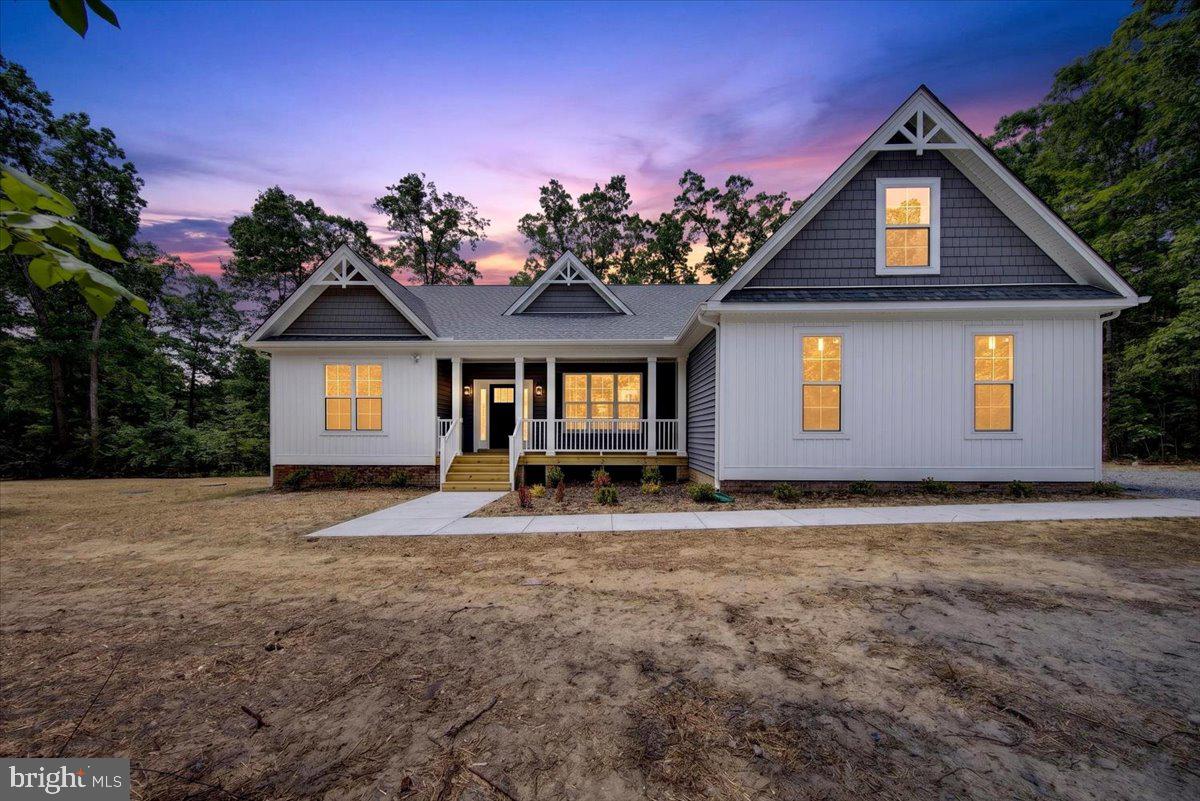 The Bancroft Model by Danaf Homes was designed for people who want space, style, and Lake Anna access without sacrificing everyday livability. Located in the highly sought-after Waters at Lake Anna community, this move-in ready new construction home sits on over 2.5 private acres and includes its own deeded boat slip (A20), which around here instantly changes the conversation.
From the moment you pull in, the curb appeal lands. Crisp white board-and-batten siding, charcoal shake accents, and clean architectural lines give the home that modern farmhouse feel buyers are chasing right now… except this one actually feels elevated instead of overdone.
Inside, the layout just makes sense. Wide open spaces, soaring ceilings, oversized rooms, and natural light everywhere. The main living area feels massive in the best way possible, anchored by a sleek fireplace and designed to flow effortlessly into the kitchen and dining areas. This is the kind of floorplan that works equally well for lake weekends, holiday gatherings, or a random Tuesday night where everyone somehow ends up around the kitchen island anyway.
The kitchen delivers exactly what buyers want without trying too hard. Quartz countertops, upgraded cabinetry, stainless appliances, oversized prep space, matte black fixtures, and a layout that keeps the cook connected to the rest of the home.
The primary suite is spacious, private, and intentionally designed with a spa-style bath featuring upgraded quartz double vanities, black hardware, a soaking tub, tiled shower surround, and clean modern finishes that feel current without feeling trendy.
And then there’s the bonus room upstairs. Whether you need a bunk room, office, media space, gym, or a spot to send the kids when the adults are trying to enjoy wine and peace for twelve consecutive minutes… it gives you flexibility most buyers realize they need after they move in.
The Waters at Lake Anna continues to be one of the lake’s most popular communities for a reason. Owners enjoy resort-style amenities, multiple common areas, pool access, and one of the strongest lifestyle communities at the lake. Pair that with over 2.5 acres and your own deeded slip, and this property hits a rare balance between privacy and lake life convenience.
New construction. Move-in ready. Deeded slip. Acreage. A smart floorplan. And built by Danaf Homes, whose reputation around Lake Anna keeps getting stronger for good reason.

Some homes are built to check boxes. This one was built to actually live in.