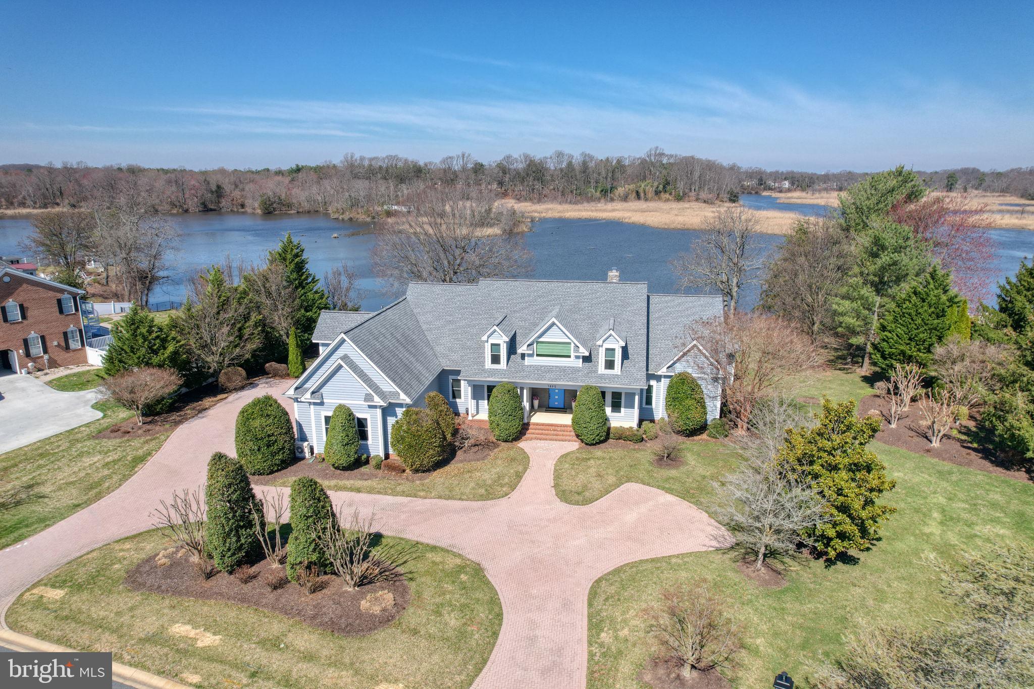 Nestled in one of Kent County's most prestigious waterfront communities, this stunning renovated home greets you with soaring ceilings, oversized windows, and breathtaking water views. The chef's dream kitchen features granite countertops, premium cabinetry, high-end appliances, and a generous center island — perfect for entertaining. The main level offers a luxurious primary suite with backyard and water access, a private office, a great room with gas fireplace, and a flexible dining area. Upstairs, three en-suite bedrooms surround a versatile loft space ideal for a media lounge or secondary living area. Outside, enjoy a heated saltwater gunite pool, hot tub, three-car garage, and an unmatched riverfront setting that truly has to be seen to be believed. This is more than a home — it's a true resort-style retreat. Schedule your tour!