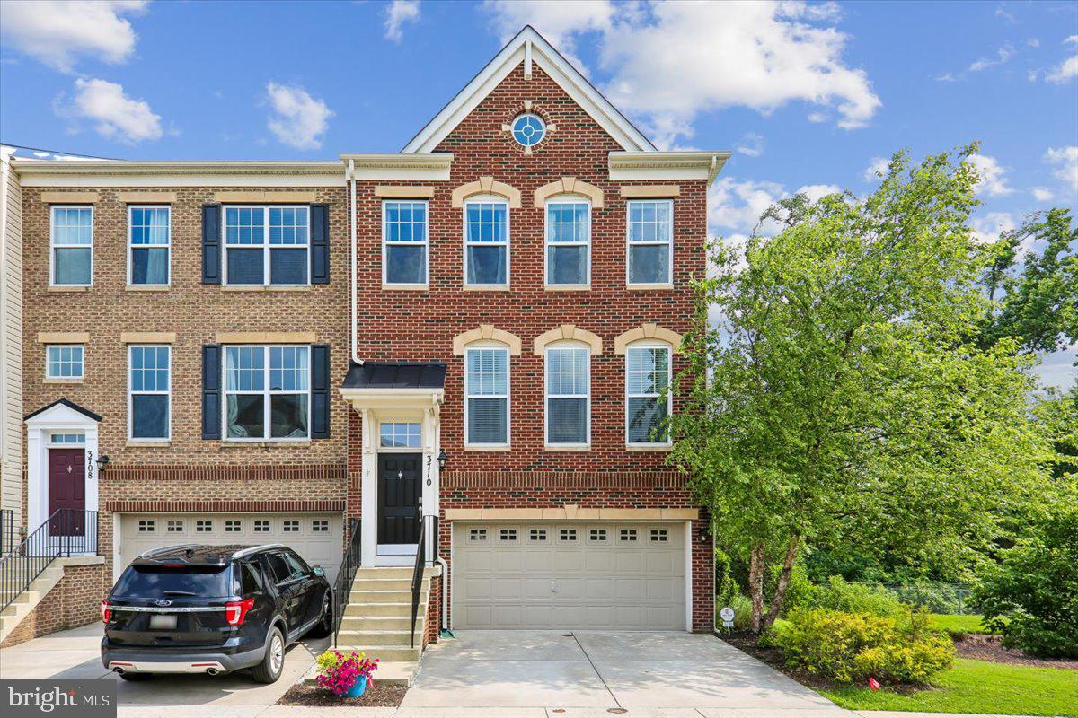 Top-notch end-unit townhome with a 2-car garage, loaded with premium upgrades and formerly the community’s model home! A welcoming foyer with a striking decorative brick accent wall leads to the expansive main level featuring 9-foot ceilings, recessed lighting  and hardwood floors throughout. The sun-filled living room overlooks the front of the home and flows seamlessly into the spacious gourmet kitchen, complete with an oversized center island, upgraded white cabinetry with glass display cabinets, quartz countertops, pantry, and stainless steel appliances. The adjoining dining area opens to the private rear deck, while the inviting sitting room showcases a designer accent wall and cozy gas fireplace. Upstairs, the luxurious primary suite offers vaulted ceilings, custom wood wall moldings, two walk-in closets, and an en-suite bath featuring a double vanity, private water closet, and an oversized tiled shower with upgraded finishes. Two additional bedrooms with recessed lighting and ceiling fans, a full hall bath with tub/shower combination and upgraded tile, and a conveniently located upper-level laundry closet with full-size washer and dryer complete the second floor. The finished walkout lower level features a spacious recreation room with large rear-facing windows, decorative accent brick wall, built-in countertop for gathering, a full upgraded bathroom, and direct access to both the backyard and the attached two-car garage. Enjoy peaceful outdoor living on the private rear deck overlooking privately owned treed land with no plans for future development. Residents of Norbeck Crossing enjoy a neighborhood playground and ample guest parking. Ideally located just minutes from the ICC, Glenmont Metro (approximately 4 miles), and everything Olney has to offer, including a wide variety of grocery stores, restaurants, fitness centers, country clubs, Montgomery County parks, and shops. This exceptional home combines luxury, convenience, and an unbeatable location.