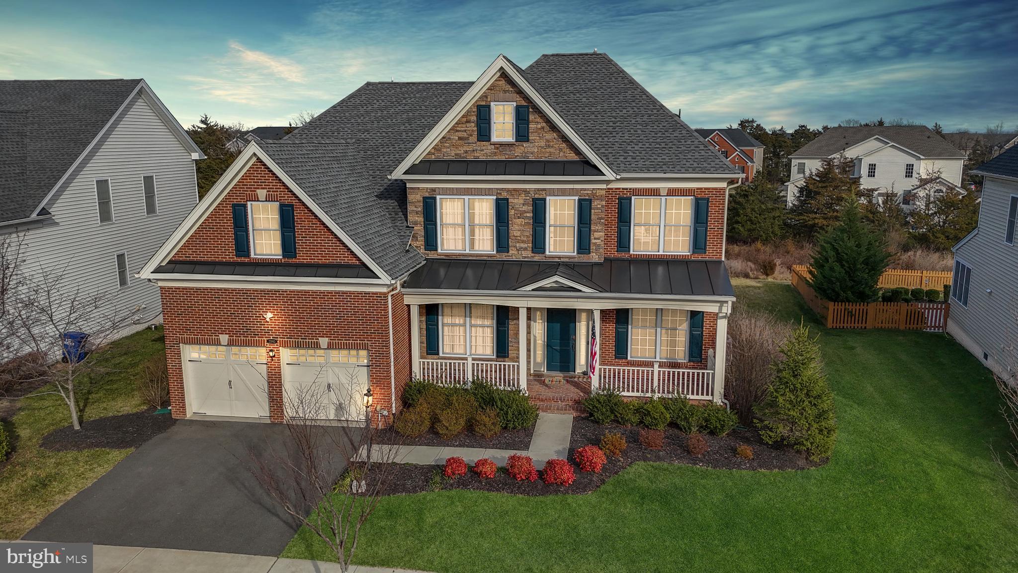 **OFFER DEADLINE 3/18 at 5 pm**With over 5,000 sqft of living space, discover the epitome of luxury living in this exceptional Ellsworth II home nestled in the highly sought-after Lenah Mill community. This stunning residence offers an unparalleled living experience, seamlessly blending timeless design with contemporary amenities.

As you step through the inviting front covered porch, the spacious entry welcomes you into the heart of the home, adorned with gleaming hardwood floors and custom molding. The main level boasts a spacious office, perfect for your work-from-home needs, and a mudroom connecting to the garage, ensuring convenience and organization.

The family room, featuring a cozy gas fireplace, is seamlessly connected to the kitchen, creating an expansive and open space for both relaxation and entertaining. Additionally, a bright and versatile sunroom off the kitchen adds an extra touch of charm and comfort to the home. The gourmet eat-in kitchen is a chef's dream, equipped with an island, plenty of counter space, stainless steel appliances, and opens to the Trex deck, creating an ideal spot for gatherings and celebrations.

Upstairs, the primary suite offers an extra sitting area, providing a private retreat within the home. The luxurious spa bath, complete with a separate RAIN shower and decadent soaking tub, adds an element of opulence to your daily routine. Three additional generously sized bedrooms, one with its own bath, and two bedrooms sharing a Jack & Jill bath, provide ample space for everyone. Abundant closet space and a laundry room on this level add to the home's functionality.

The lower level of this home is designed for entertainment, featuring a spacious rec room, a Theater room, a full bar, a full bath and steam shower, and a large storage room.  All new tiling in the downstairs as well. An outside entrance leads to the back yard, bordered by mature trees for added privacy. The large Trex deck invites you to enjoy the outdoors and provides an excellent space for gatherings.

This residence is situated in the highly sought-after Lenah Mill community, surrounded by the natural splendor of Loudoun wine country. Residents enjoy an array of resort-style amenities, including a fitness center, clubhouse, splash and play pools, tot lots, ponds, playing fields, an amphitheater, a dog park, basketball and volleyball courts, a boathouse lake, pavilions, and tennis courts. The community offers over 300 acres of natural green spaces, walking trails, and community events.

Strategically situated, this home ensures effortless access to nearby restaurants and stores, creating a shopper's paradise within a short drive. Offering an exceptional blend of elegance and comfort, this extraordinary residence provides seamless connectivity to Dulles International Airport, the lush landscapes of Loudoun County, and the convenience of the Silver Line, making commuting to Dulles and Tysons effortlessly smooth. Don't miss the chance to make this your dream home in the heart of Lenah Mill!

Certain lots within Lenah Mills lie within the Airport Impact Overlay District (within the 1 Mile Buffer). Due to its proximity to Dulles International Airport, this site is subject to aircraft overflights and aircraft noise.