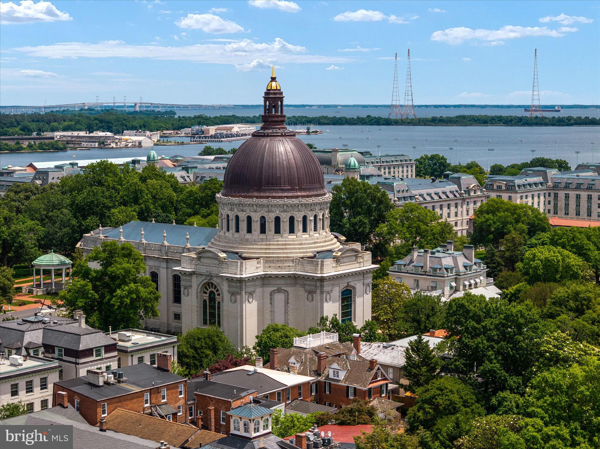 Perfectly positioned on one of the most coveted streets in Historic Annapolis, just steps from State Circle, the United States Naval Academy, City Dock, waterfront dining, boutiques, and yacht clubs, 238 King George Street offers a rare opportunity to own a completely reimagined luxury residence in the heart of Maryland’s capital city. Blending timeless historic charm with the modern conveniences today's discerning buyer expects, this exceptional home was extensively renovated and expanded in 2006–2007 and thoughtfully updated through 2025, including a new roof, HVAC systems, and water heater. Inside, four beautifully finished levels offer elegant living and entertaining spaces filled with natural light, custom millwork, rich hardwood flooring, high ceilings, and refined architectural details throughout. The gourmet kitchen opens seamlessly to inviting gathering spaces designed for both intimate evenings and large-scale entertaining, while the finished lower level with high ceilings and private walk-out entrance provides exceptional flexibility for guests, recreation, or a private office. The upper-level loft retreat offers additional living space ideal for guests, a studio, or a luxurious private sanctuary. Enjoy views of the iconic Naval Academy Chapel dome, a daily reminder of the unparalleled location and lifestyle this home affords. Rare off-street parking adds tremendous value and convenience, while the lock-and-leave nature of the property makes it ideal as a primary residence, weekend retreat, or executive pied-à-terre. Offered substantially furnished with only a few exclusions, this remarkable home provides the opportunity to move in and immediately begin enjoying the very best of Annapolis living. Luxury, history, walkability, and convenience converge at one of the city's most prestigious addresses.