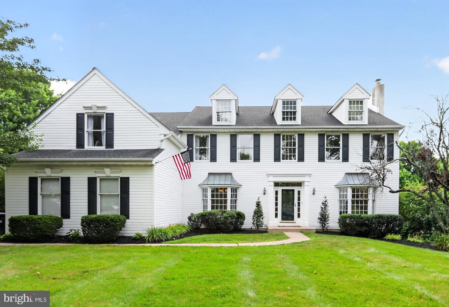 Welcome to this exceptional Waverly model in the highly desirable Milestone neighborhood, where timeless elegance meets thoughtful updates and modern convenience. This center hall colonial features a two-story foyer, turned staircase with hardwood treads, crown molding, a guest closet (with a secret closet at the rear), and a powder room. Hardwood flooring extends through most of the first floor, complemented by upgraded lighting, smart home features, plus quality craftsmanship. The perfectly sized living room features crown molding and custom built-ins with lighted glass shelves. The formal dining room is designed for entertaining and showcases a large bay window with blinds, custom lighted alcoves with enclosed cabinetry, beautiful wainscoting, five-piece crown molding, and a gas fireplace that creates a warm and inviting focal point. Adjacent is the first-floor study which offers additional built-in shelving, desks, cabinetry and a pocket door to the kitchen. The gourmet kitchen is truly a chef's dream, featuring 42-inch cherry cabinetry, granite countertops, a decorator stone backsplash, under-cabinet lighting, Dacor double gas ovens with griddle, a built-in microwave, a deep bowl European sink, a prep sink with a gooseneck faucet, a beverage refrigerator, a pantry cabinet, pot drawers, a large pull-out spice cabinet, a lazy Susan, quiet-close drawers, and leaded glass upper cabinets with accent lighting.  At the laundry room entrance there are additional pantry-like storage cabinets. The adjoining family room impresses with its soaring two-story vaulted ceiling, rear staircase, and sliding doors leading to the expansive deck overlooking the beautifully landscaped backyard. This room is centered by a custom boxed in electric fireplace, which adds ambiance and warmth. The oversized laundry and mud room includes built-in cubbies, coat hooks, shoe and boot storage, a folding counter, abundant cabinetry, the included washer and dryer with a worktop area, a side-by-side refrigerator and convenient access to both the attached two-car garage and an exit door to the driveway. Upstairs, the spacious primary suite includes a vaulted ceiling and a private sitting room currently used as a dressing area. The suite features two walk-in closets, an additional storage closet, walk-in attic area and a recently remodeled private bath with a luxurious doorless walk-in shower and vessel tub. Three additional generously sized bedrooms provide excellent closet space, including one bedroom enhanced with custom wainscoting, wallpaper, and fresh paint. The hall bath features ceramic tile, double sinks, and a linen closet.  The finished walk-out lower level offers outstanding additional living space! The 19' x 18' family room features a custom wet bar with a sink and glass/brass shelving, abundant cabinetry, a beverage refrigerator plus wine refrigerator along with updated flooring, walls, and a unique, functional ceiling. Do not miss the "hidden" TV (included) which rises up to catch that additional program you might want to see. There is a 16' x 10' office concealed behind a hidden bookcase door complete with built-ins and a full window to the exterior, an exercise room with padded flooring, a sports equipment storage closet, and a holiday decoration storage room with built-in shelving. Direct access to the slate patio with a stone wall makes this level as functional as it is impressive. (Don't miss the large unfinished area with storage shelves and a large workbench.) Outdoor living is equally inviting with a spacious deck, stairs leading to the patio below, and professionally landscaped grounds enhanced by landscape lighting. Ideally located in award-winning Methacton School District and just minutes from shopping, restaurants, services, and Route 476, this exceptional home offers an outstanding combination of luxury, comfort, thoughtful design and unbeatable location! Must see to appreciate what's not included above!