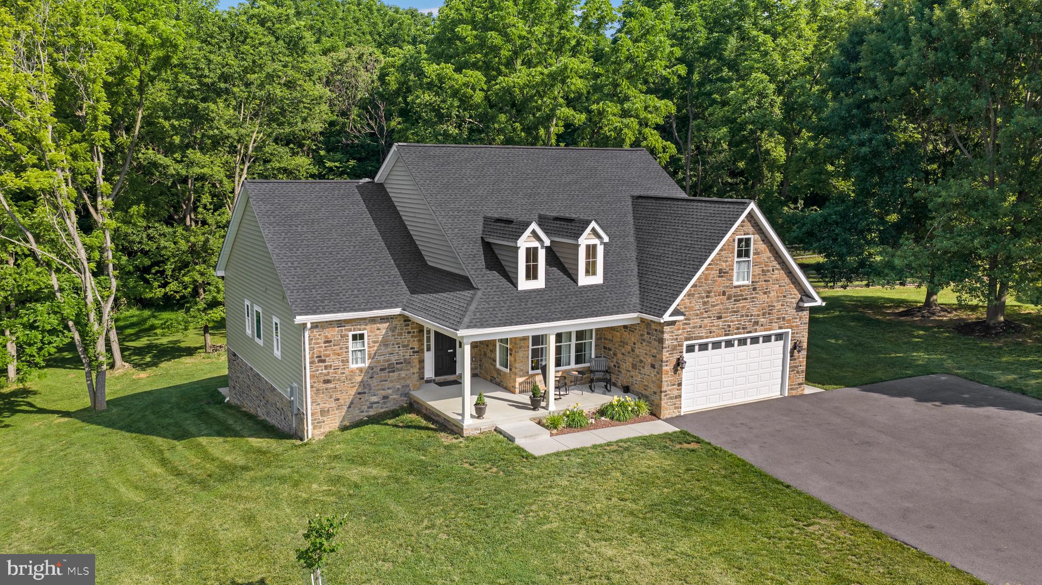 Beautiful Ranch Home in Eastland Subdivision – Charles Town, WV

Don't miss this exceptional 3-year-young rancher in the desirable Eastland Subdivision area of Charles Town! Offering 4 bedrooms, 3 full baths, and 2,871 finished square feet, this home combines modern elegance with comfortable one-level living.

Step inside to discover 9-foot ceilings throughout and a stunning vaulted ceiling in the main living area, highlighted by a floor-to-ceiling stone gas fireplace. Crown molding adds a touch of sophistication, while the gourmet kitchen features quartz countertops, quality appliances, and ample space for entertaining. A separate dining room provides the perfect setting for family meals and special occasions.

The spacious primary suite boasts a tray ceiling, double-sink vanity, walk-in shower, and generous closet space. Enjoy outdoor living from the covered front porch or relax on the covered rear deck overlooking the beautiful park-like 1-acre lot.

Additional features include a full walk-out unfinished basement offering endless possibilities for future expansion, a 2-car garage, and an oversized paved driveway.

This move-in-ready home offers the perfect blend of style, space, and privacy. Homes like this don't stay on the market long—schedule your showing today!