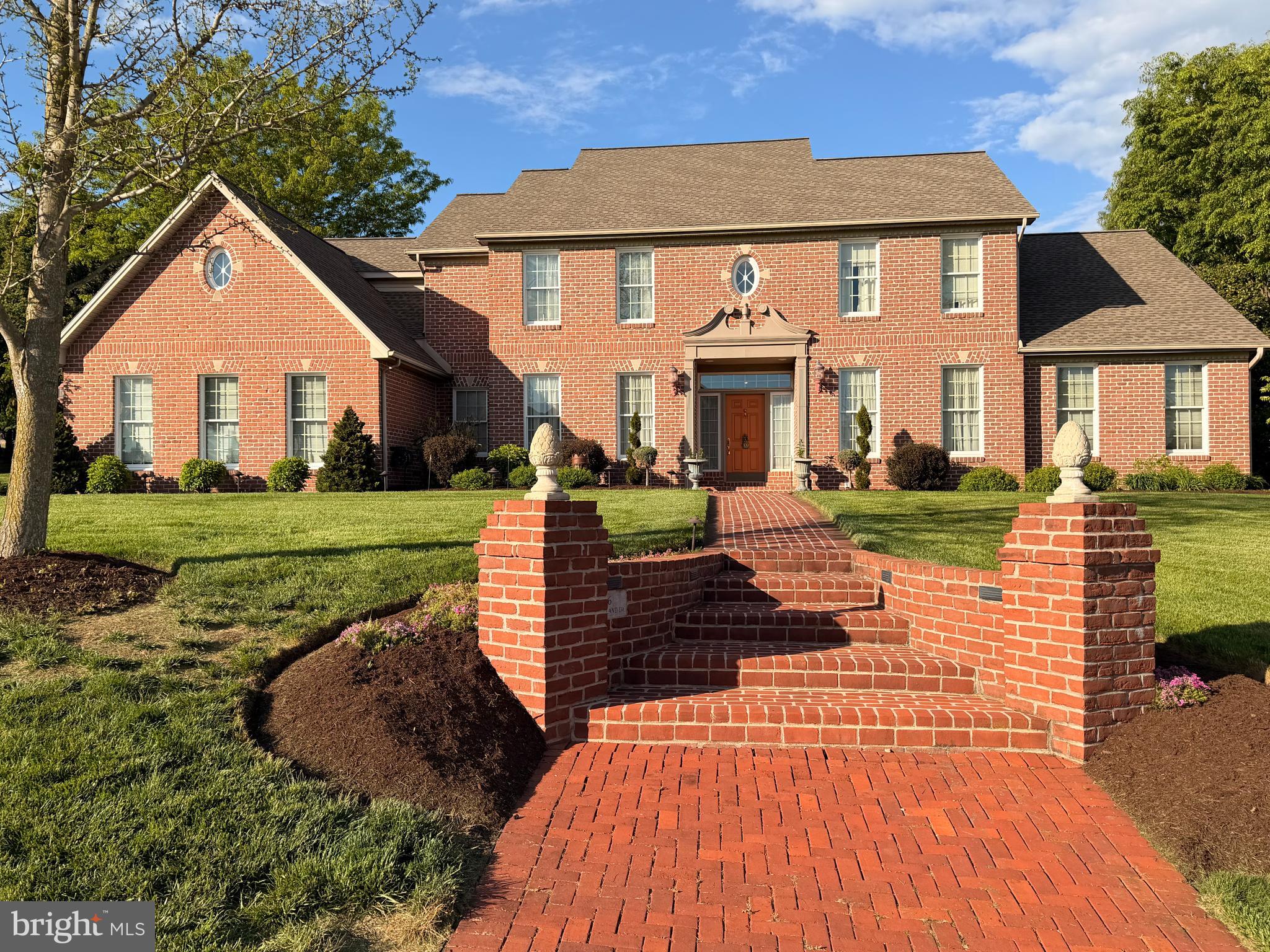 Refined Elegance & Exceptional Living in a Premier Community less than 1 mile from Hershey/Derry Township.
Nestled within a small, highly desirable North Hills community overlooking Hershey.  This magnificent  two-story residence offers a rare combination of timeless elegance, thoughtful design, and serene surroundings featuring 5600+ SF of finished living area. Set against a backdrop of open fields with sweeping views and exceptional privacy, this distinguished home delivers both sophistication and everyday comfort.
From the moment you arrive, the home’s stately presence and manicured landscaping set the tone. Brick sidewalks lead from the street and driveway to a covered porch. Step inside to a grand two-story foyer, where natural light pours in and creates an unforgettable first impression. Flanking the entry are a gracious music room/ living room and an expansive formal dining room, both beautifully appointed with crown molding and chair rail, offering the perfect setting for elegant entertaining.
The heart of the home is the custom "Kountry Kraft" gourmet kitchen, masterfully designed with rich, high-quality cabinetry, gleaming granite countertops, and generous workspace. A striking semicircular breakfast room, wrapped in windows, invites the outdoors in and provides a bright and inviting space for casual dining.
The dramatic two-story great room is both warm and impressive, centered around a marble surround  fireplace and enhanced by a soaring 19' ceiling and architectural catwalk above, creating a sense of openness and connection between levels. Adjacent to the main living space, a spacious private den offers flexibility as a refined home office or quiet retreat.
A highlight of the home is the expansive sunroom, a true sanctuary overlooking the beautifully landscaped backyard curated by a former President of the Garden Club with perennial plants , deciduous and evergreen trees providing beauty year round and featured in public tours. This outdoor haven has been thoughtfully designed for both relaxation and entertaining, highlighted by an elegant fountain, a synthetic deck which turns into a 3 section paver stone patio providing a shaded area. The top of the lot features a  charming 12' x20' poured concrete pergola providing privacy and picturesque views of the backyard. The yard also includes underground electric, running water, hardwired low voltage LED lighting and  propane hookups. Function meets style with a well-appointed first-floor laundry room, complete with built-in cabinetry for added convenience and organization.
The second level offers three generously sized bedrooms, each featuring walk-in closets and full baths, ensuring comfort and privacy for family members and guests alike. The open catwalk provides a stunning overlook to the great room below, enhancing the home’s architectural appeal.
The mostly finished walkout lower level is a remarkable extension of the home’s living space and offers incredible versatility. It features a large media room with gas fireplace and built-in cabinetry, expansive recreation room, full bath, and a second kitchen. With fully exposed windows and a patio door leading directly to a private patio w/a granite top bar and tranquil pond, this level feels bright, inviting, and entirely self-contained—ideal for multi-generational living or extended stays.
Additional highlights include an energy-efficient geothermal HVAC system, central vacuum, 3-car garage plus a lower level Potter's garage, great built-in storage, Bluetooth whole -house music and a thoughtfully designed layout that balances open-concept living with defined, functional spaces.
Perfectly located with convenient access to Hershey’s renowned amenities and the Medical Center—and offering scenic views of both—this exceptional property presents a rare opportunity to own a home that truly embodies elegance, comfort, and refined living.