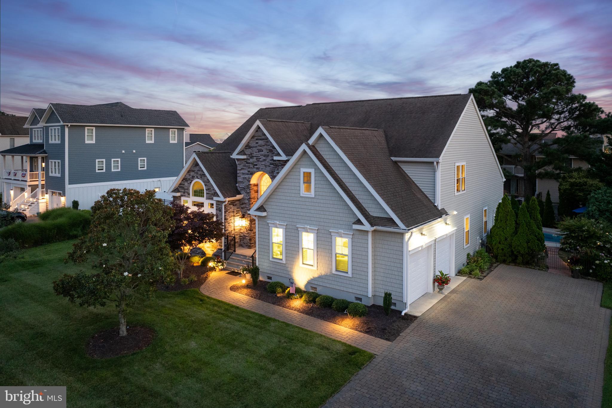 "PICTURE PERFECT" in RBYCC! Imagine summer days spent floating in your private saltwater pool and evenings enjoying glimpses of bay and golf course views in one of the Delaware coast’s premier communities from this 4+ bedroom home located only steps from the golf course and Rehoboth Bay! Spanning nearly 3,900 square feet of meticulously updated living space, this residence offers the ultimate blend of coastal sophistication, everyday functionality, and resort-style living. 

Step through the newly installed front door into a soaring, light-filled grand foyer featuring a magnificent open staircase. Flowing effortlessly beyond, the two-story Great Room boasts custom built-ins, a cozy gas fireplace, and a dramatic wall of windows complete with custom remote-controlled roller shades. Conveniently adjacent sits the newly remodeled kitchen, showcasing quartz countertops, a chic tile backsplash, Café series lighting, and a new sink with disposal switch.

The main floor seamlessly transitions into a sunny breakfast nook, a formal dining room, a dedicated private office, and a sunroom framed by lush outdoor views. Serving as a true sanctuary, the spacious first-floor primary suite features high ceilings, dual walk-in closets, and a spa-like en-suite bath equipped with double vanities, a glass shower, and a premium "Bain Ultra" air jet hydrotherapy soaking tub. 

Upstairs, you will find 3+ additional guest bedrooms and two full bath, including a tiled Jack-and-Jill setup, along with slight views of the nearby golf course greens and sparkling bay. Outside, your private backyard oasis awaits, anchored by an in-ground saltwater pool, a hardscaped paver patio, mature landscaping with pathway spotlights, an outdoor shower, and full aluminum fencing. Designed for complete peace of mind, recent major upgrades include brand-new 2024 vinyl siding and stone accents, replacement windows, new exterior doors, upgraded HVAC units with custom screening, a crawl space dehumidifier, a private irrigation well, and motorized exterior window awnings.

Don't wait to start living the "picture perfect" coastal lifestyle you deserve - schedule your showing of this extraordinary Rehoboth Beach home today!