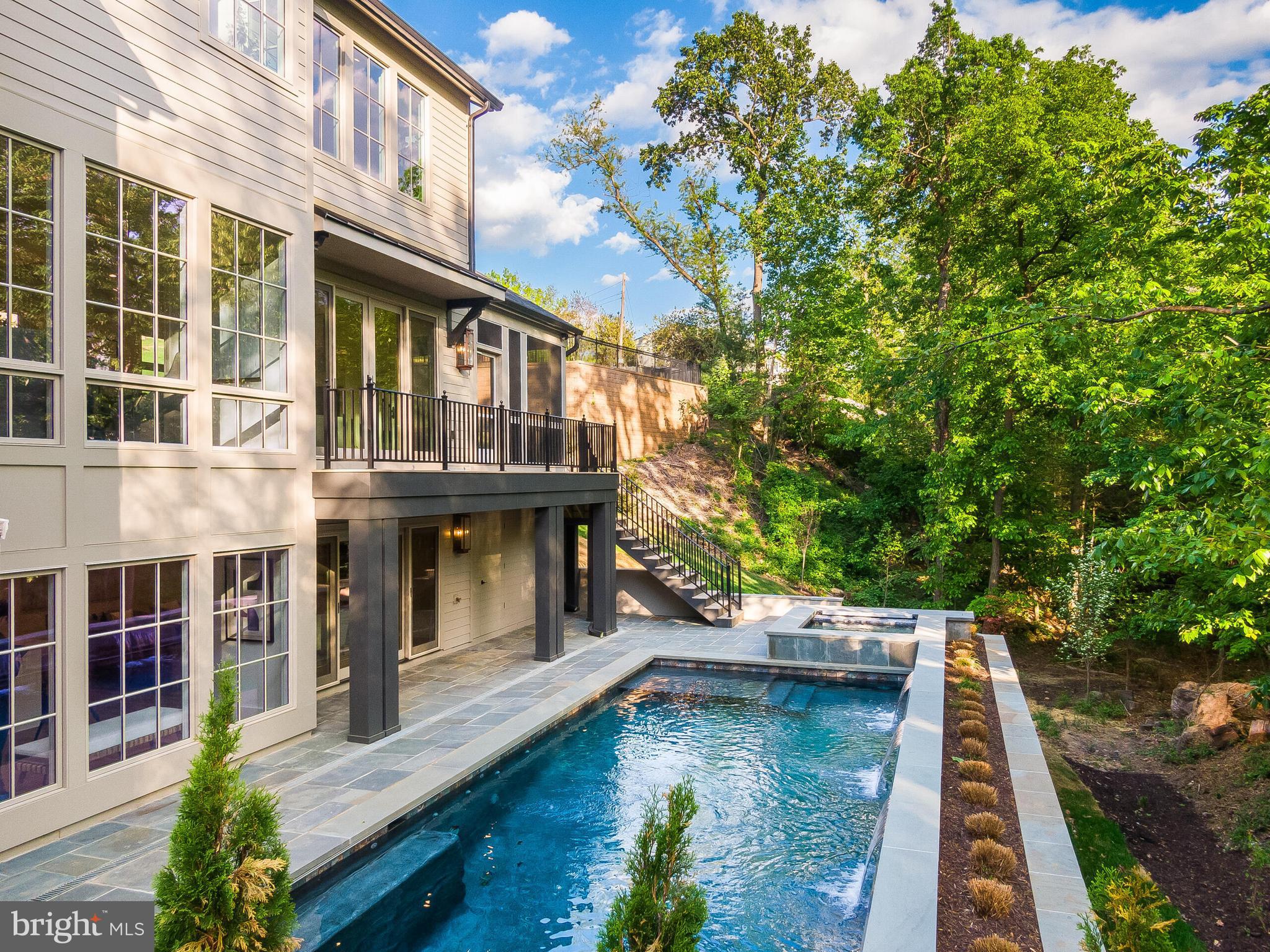Welcome to an extraordinary custom residence by Classic Cottages, set on a quiet, oversized lot in sought-after Seminary Hill—complete with a stunning heated pool and hot tub that create your own private resort-style retreat. Thoughtfully designed and meticulously crafted, this home blends refined elegance with effortless indoor-outdoor living.

From the moment you step inside, you’re greeted by sun-drenched interiors and exceptional attention to detail at every turn. The main level features a private office wrapped in floor-to-ceiling windows, complete with its own walkout porch—an inspiring space for work or quiet retreat. The heart of the home is the grand gourmet kitchen, seamlessly connected to a formal dining area and an expansive great room. Here, the great rooms opens to a screened-in porch with a cozy fireplace, creating the perfect setting for year-round entertaining. A balcony off the great room, along with a well-appointed mudroom and designer powder room, complete the main level.

Upstairs, you’ll find four spacious bedrooms, each with its own en suite bath, offering comfort and privacy for family and guests alike. The luxurious primary suite is a true sanctuary, featuring a spa-like bath and an oversized walk-in closet. A conveniently located upper-level laundry room adds everyday ease.

The lower level is designed for entertaining on a grand scale. A sprawling recreation room with a fully equipped bar—featuring a dishwasher and beverage center—opens directly to the outdoor living spaces, including a lower deck and the pool area. Unwind in the sauna, host overnight guests in the additional bedroom and full bath, or enjoy the dedicated exercise room.

Outdoors, the experience continues with multiple spaces for lounging and entertaining, all centered around the show-stopping heated pool and hot tub—perfect for relaxing evenings or lively gatherings.

With top-of-the-line finishes throughout, abundant natural light, and easy access to I-395 for seamless commuting, this exceptional home offers the perfect balance of luxury, comfort, and convenience.