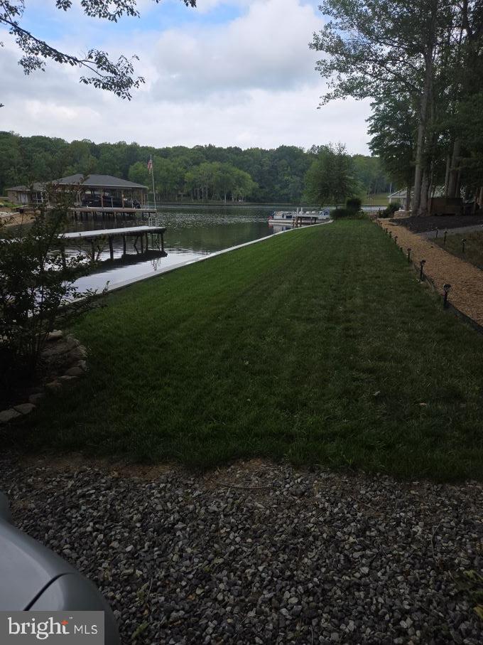 Build your dream waterfront home on this incredible lot on the public side of Lake Anna! Featuring approximately 180 feet of shoreline, this beautiful property offers expansive water views, a gentle waterfront, and everything you need to start enjoying lake life immediately.

The lot is beautifully landscaped and ready for relaxing weekends or future construction. Enjoy your own white sandy beach, gather with family and friends around the fire pit, and spend your days boating, fishing, swimming, or kayaking from your private boat pier with slip.   There is a large elevated, shaded picnic area & a shed with ample space for boat gear and tool storage.

Located in a desirable waterfront community near Pleasant's Landing, you'll love the convenience of easy access to marinas, restaurants, and all that Lake Anna has to offer while still enjoying the peace and privacy of your own waterfront retreat.

Whether you're planning to build a full-time residence or a vacation home, opportunities like this—with 180 feet of waterfront on the public side of Lake Anna—are becoming increasingly rare.   Lot is perked for a 4 bedroom home.

Bring your builder and your vision, and start making memories on the lake!