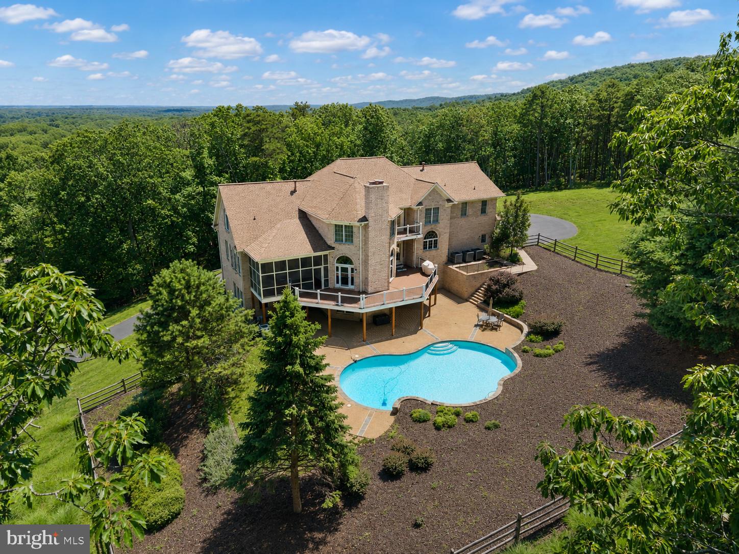 Nestled on over 10 pristine acres in the highly sought-after Thunder Oak community, this exceptional custom estate built by Creighton Enterprises offers the perfect blend of luxury, craftsmanship, and resort-style living. Showcasing exquisite custom millwork and moldings, five fireplaces, and hardwood flooring throughout the main and upper levels, this home was designed with both elegance and comfort in mind.

A grand two-story foyer welcomes you into the home, flanked by formal living and dining rooms. The expansive sunken family room serves as the heart of the home and flows seamlessly into a light-filled sunroom. The main level also features two half baths, a gourmet kitchen with top-of-the-line appliances, abundant cabinetry, an oversized eat-in area, and access to both the spacious deck and screened porch—perfect for indoor-outdoor entertaining.

Upstairs, the luxurious primary suite offers a private retreat complete with a fireplace, sitting room, multiple walk-in closets, and a versatile bonus space ideal for a nursery, home office, fitness room, or private lounge. Three additional generously sized bedrooms, two full bathrooms, and a large laundry room complete the upper level.

The walkout lower level is truly an entertainer's dream, featuring a kitchenette, theater room with digital projector, 102" screen, theater seating, surround sound system, whole-house amplifier, and direct access to the backyard oasis. An additional den or fifth bedroom and 2 full bathrooms provide flexible living options for guests or extended family. There are also two utility rooms that allow for multiple storage options. 

Step outside to enjoy the stunning saltwater pool with expansive patio surround, creating a private resort-like setting amidst the property's beautiful acreage. Additional highlights include a whole-house generator and meticulously maintained, updated critical systems, providing peace of mind for years to come.

A rare opportunity to own a premier custom estate in one of the area's most desirable communities. See  the documents section for a full list of recent updates and information on this home.