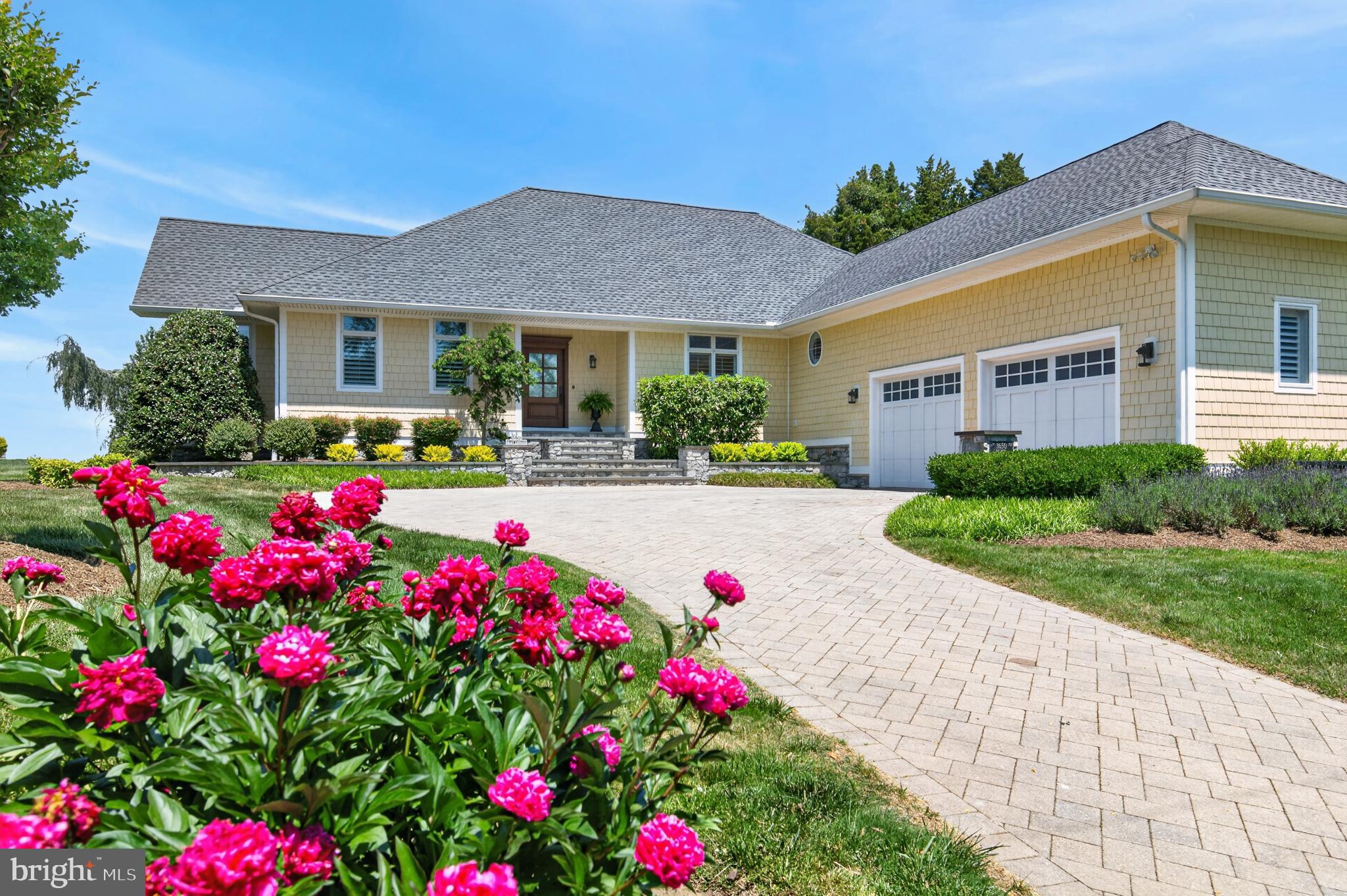 Welcome to 3650 Bay Drive, an exceptional waterfront retreat on the coveted shores of Turkey Point Island in Edgewater. Set on a rare double lot with 150 feet of waterfront, a private beach, and sweeping western sunset views, this impeccably maintained home offers the ultimate Chesapeake Bay lifestyle. Built in 2012 and designed for effortless main-level living, this turn-key four-bedroom, three-and-a-half-bath residence offers 3,125 square feet of beautifully appointed living space. The open-concept design seamlessly connects the living and dining areas to a gourmet kitchen featuring a dramatic marble island, custom cabinetry, new Sub-Zero refrigerator, GE appliances, and gas cooking—perfect for everyday living and elegant entertaining. The main-level primary suite is a private waterfront sanctuary with direct access to the expansive waterside deck, panoramic views, and a luxurious spa-inspired bath including heated floors. A second ensuite bedroom, along with two additional bedrooms, provides comfortable accommodations for family and guests. Exceptional craftsmanship is evident throughout with rich oak hardwood floors, classic moldings, hurricane-rated windows, plantation shutters, Hardie Plank siding, and a 50-year architectural roof. Energy-efficient geothermal heating and cooling provides comfort and cost savings plus a whole house generator that insures  peace of mind  year round. The lower level offers an additional 3,125 square feet of flexible space, including a large utility room, workshop, full bath, and the opportunity to create additional living areas with direct  walkout access to the waterfront.  The oversized two-car garage includes a hydraulic lift accommodating a third vehicle. Outside, mature landscaping, irrigation, gentle bay breezes, and expansive outdoor spaces create a serene setting where every day feels like a vacation. The updated private pier features two slips with approximately 5-6 feet of MLW, providing excellent access to the Chesapeake Bay. Enjoy boating, private beach days, and unforgettable sunsets from your own backyard. Located in the welcoming waterfront community of Turkey Point Island, this rare offering combines privacy, quality craftsmanship, modern comfort, and the timeless beauty of waterfront living.