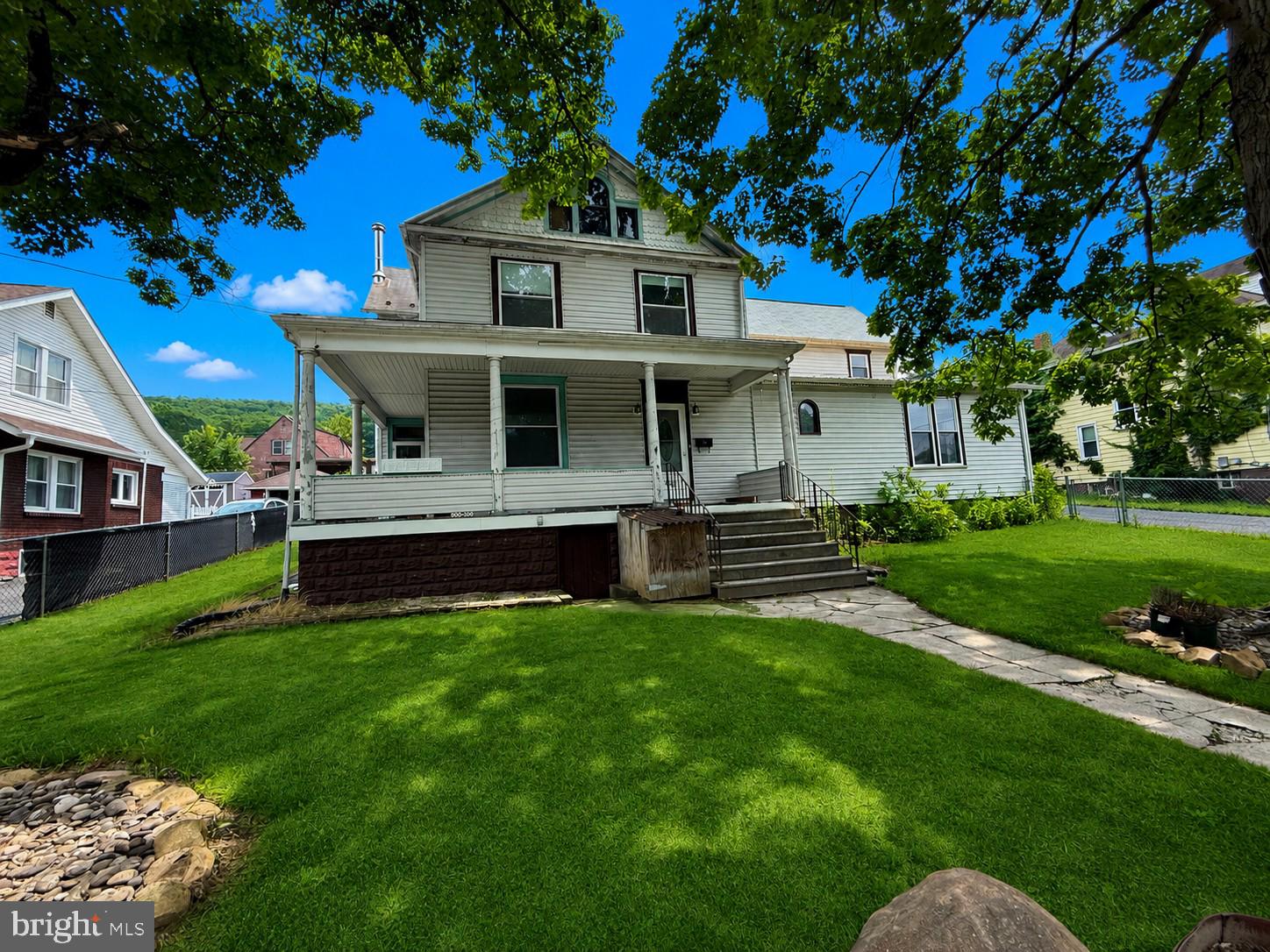 Classic Charm, Incredible Space, and Endless Possibilities! Packed with character and overflowing with potential, this spacious 4-bedroom, 2-bath home in LaVale offers the perfect opportunity to create your dream home while enjoying the timeless details that make older homes so special. From the inviting wraparound porch to the beautiful original trimwork throughout, this home is filled with classic charm. Inside, you'll find generously sized rooms, a large kitchen with plenty of space for gathering, and a flexible layout ready to fit your lifestyle. One of the home's standout features is the expansive additional suite, complete with its own full kitchen, dining area, and living room. Whether you envision the ultimate recreation room, game room, playroom, hobby space, home office, guest retreat, or entertaining area, this versatile space offers endless possibilities to make it your own. Step outside to enjoy the fully fenced half-acre yard with plenty of room for pets, gardening, outdoor gatherings, or simply relaxing. A detached garage, oversized driveway, and central air conditioning add comfort and convenience to this unique property. With its generous square footage, flexible living spaces, classic architectural details, and exceptional outdoor setting, this LaVale home is full of opportunity. Bring your ideas, add your personal touch, and unlock the incredible potential this one-of-a-kind property has to offer!