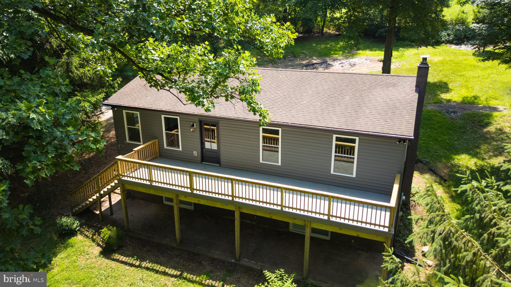 Welcome to 1108 Osceola Dr, a completely remodeled 4-bedroom, 2.5-bath retreat tucked away on a private, wooded .87-acre lot in scenic Drumore. Free from the confines of a development, this home offers the peaceful seclusion of towering poplar and pine trees while delivering thoroughly modern comforts throughout.

Step inside to discover a brand-new kitchen designed to impress, featuring crisp new cabinetry, gleaming quartz countertops, a tiled backsplash, all-new stainless steel appliances, and a large center island perfect for gathering. Luxury vinyl plank flooring flows seamlessly across the main living spaces, complemented by brand-new windows and freshly installed interior and exterior doors.

The primary bathroom has been beautifully reimagined with a walk-in tiled shower, a new vanity, tiled floors, and updated fixtures. Every bath—including the convenient half bath in the finished walkout basement—reflects the same attention to detail.

Downstairs, the finished basement expands your living options with a spacious 24x20 family room, the fourth bedroom, and a generous laundry area.

Outdoor living shines here. Relax on the expansive 36x9 rear deck or enjoy morning coffee on the newly built 10x10 front deck. A massive 34x18 detached garage, wired with electricity and a side entrance, provides ample space for vehicles, hobbies, or storage.

Nature lovers will appreciate the nearby Willis & Elsie Shenk Nature Preserve, while families benefit from proximity to Solanco High School. Move-in ready and thoughtfully updated, this home invites you to start your next chapter. Schedule your private tour today!